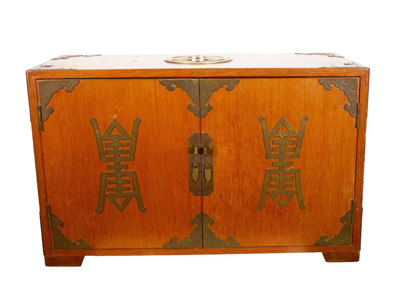 An elegant antique Asian wood box with brass ornate details. Doors with ornate handles open to six inner drawers. Each drawer is also decorated with ornate brass details with handles. Each drawer is lined. Could be used for jewelry storage or for