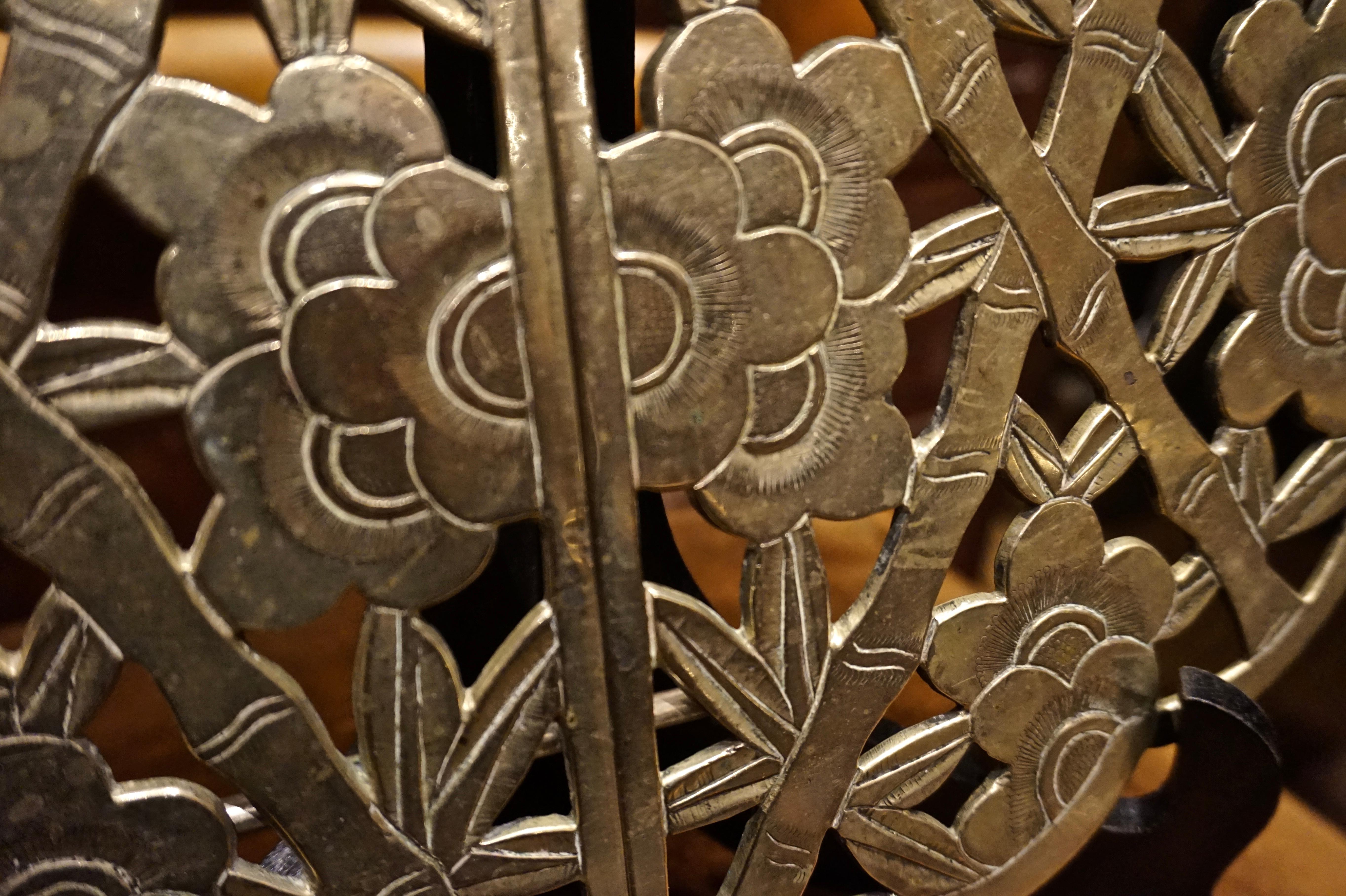 Hand engraved expanding tea trivet with unique design and exuding finesse. May be used as a decorative screen, plaque or objet d'art, circa 1900-1910.

    