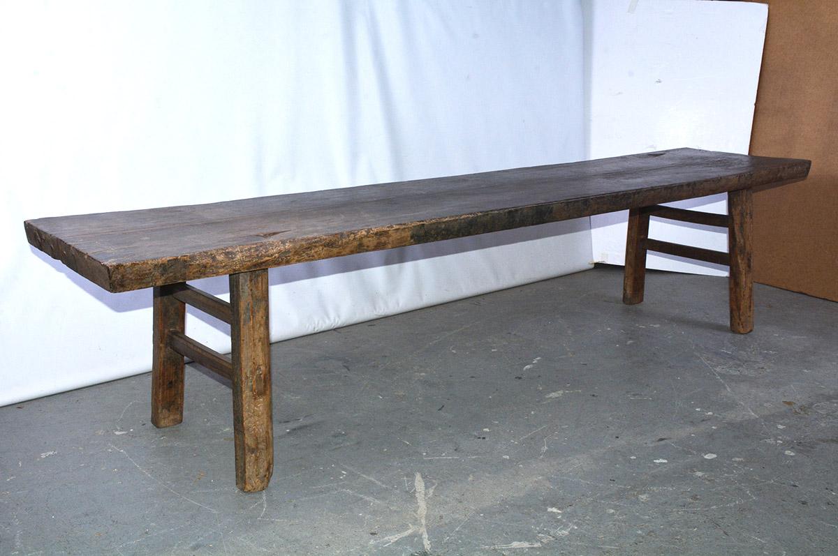 The antique Asian handcrafted teak wood bench also meets the criteria as a coffee table. A pair of double stretchers and the legs are secured by solid pegged construction. Excellent for outdoor/indoor use.
