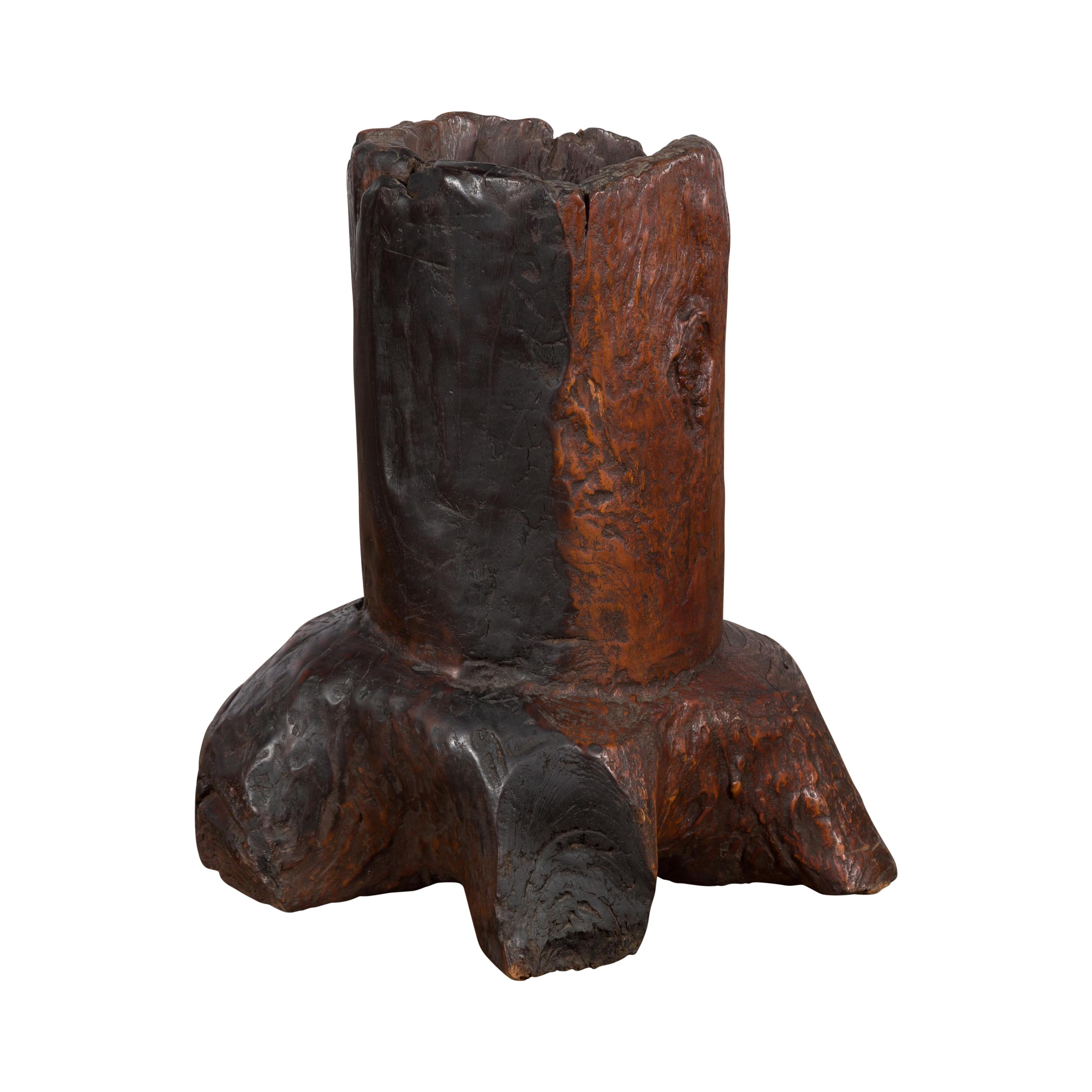 A Primitive teak wood Folk style wooden tree trunk mortar from the 19th century with distressed appearance, ideal to be used as a rustic planter. Created in Asia possibly during the 19th century, this teak wood piece attracts our attention with its