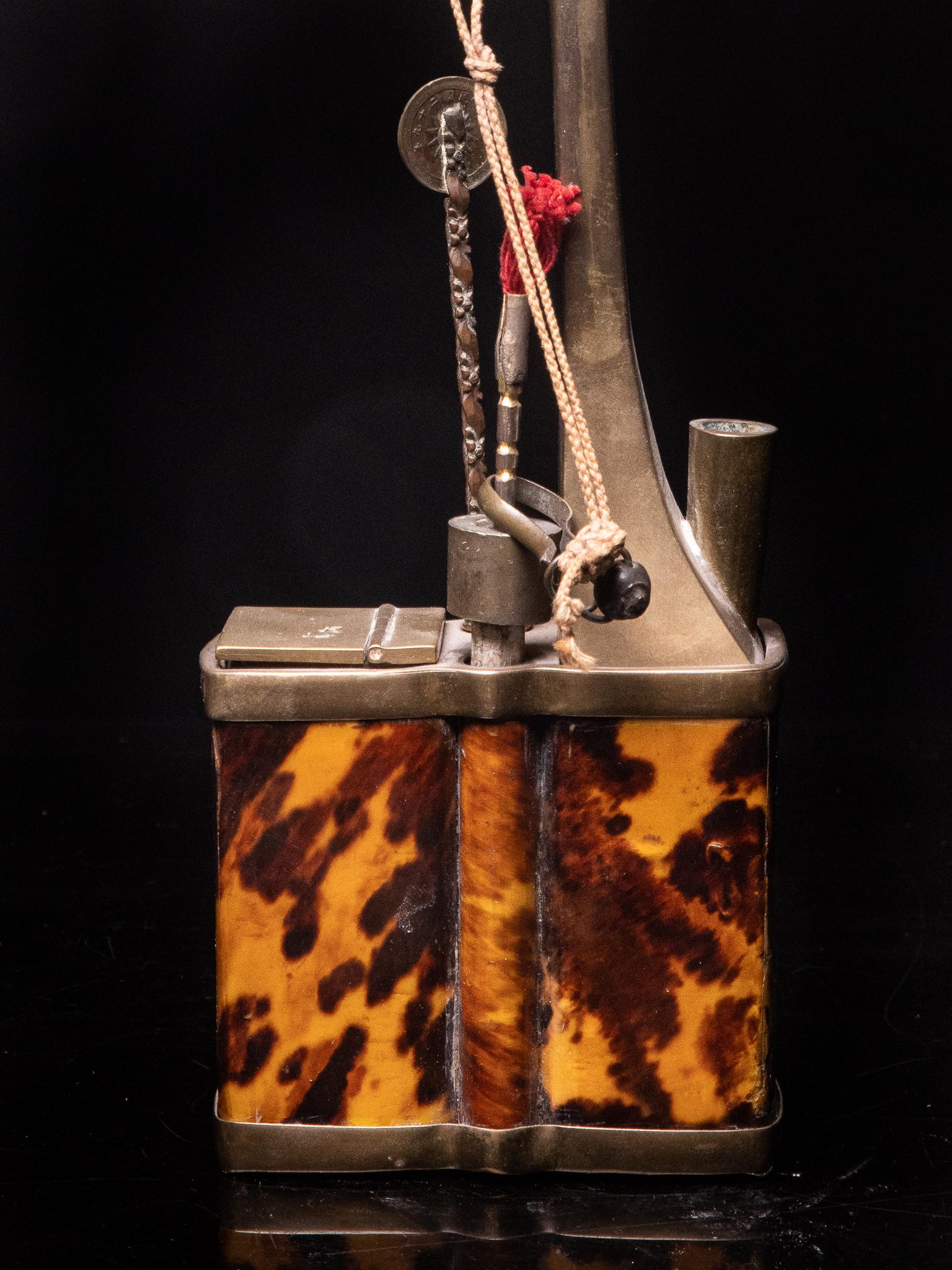 Antique Chinese Water Pipe in Yellow Copper, decorated with Tortoiseshell Scales. The Rectangular Base gives this Object its Elegance. 

French Private Collection.