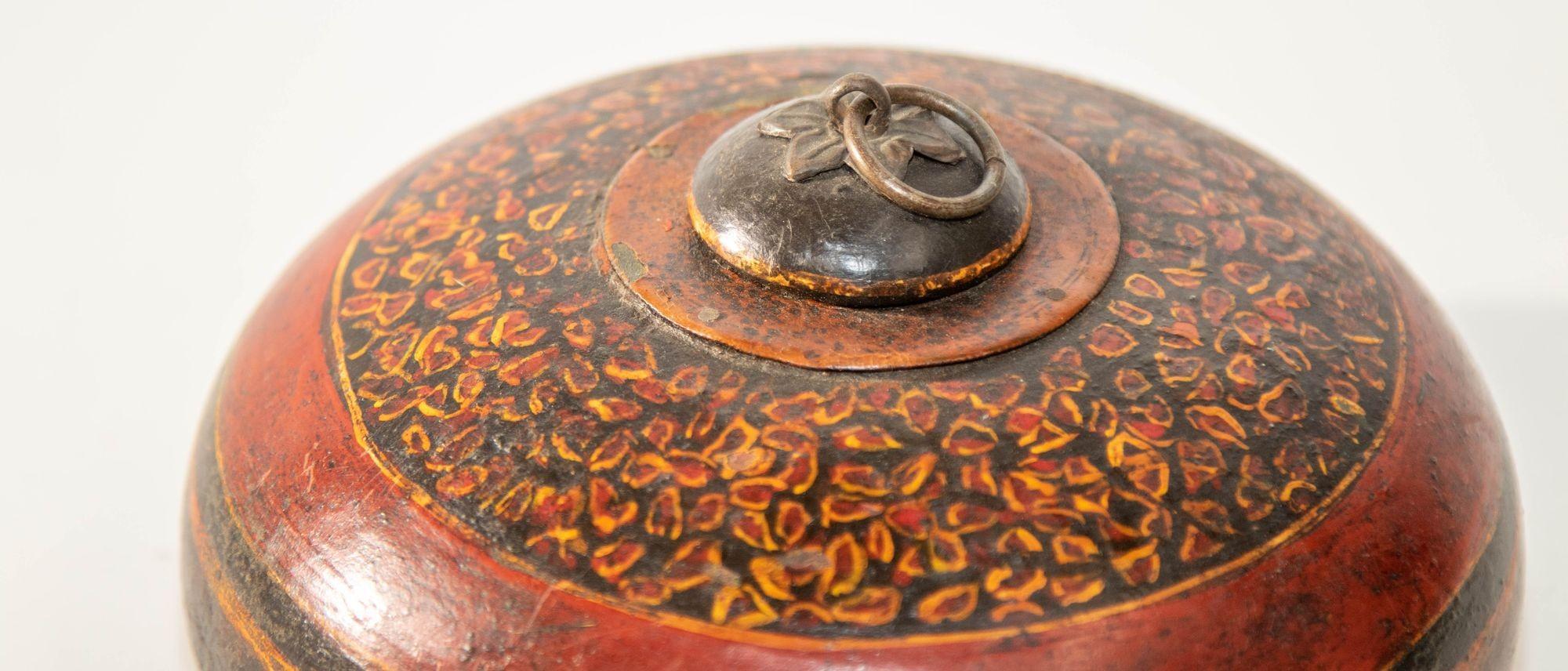 Decorative Antique Asian round wood box container with lid and brass pull.
Vintage collectible Asian wooden tobacco or opium round container.
Round shaped lidded opium container box, hand crafted and hand painted wooden box with brass fittings
