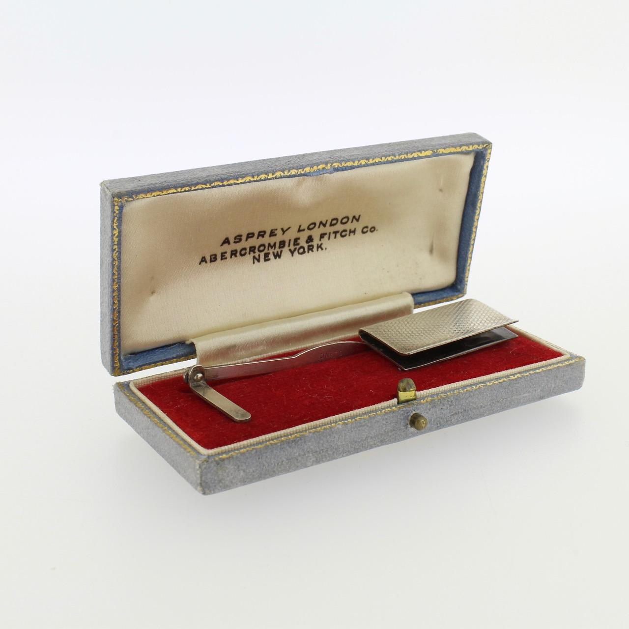 A good Art Deco period sterling silver mechanical bookmark by Asprey & Co.

The bookmark slips over a book cover or group of pages and has a spring action arm that holds its page in place. 

Complete with its original felt lined case (that bears a