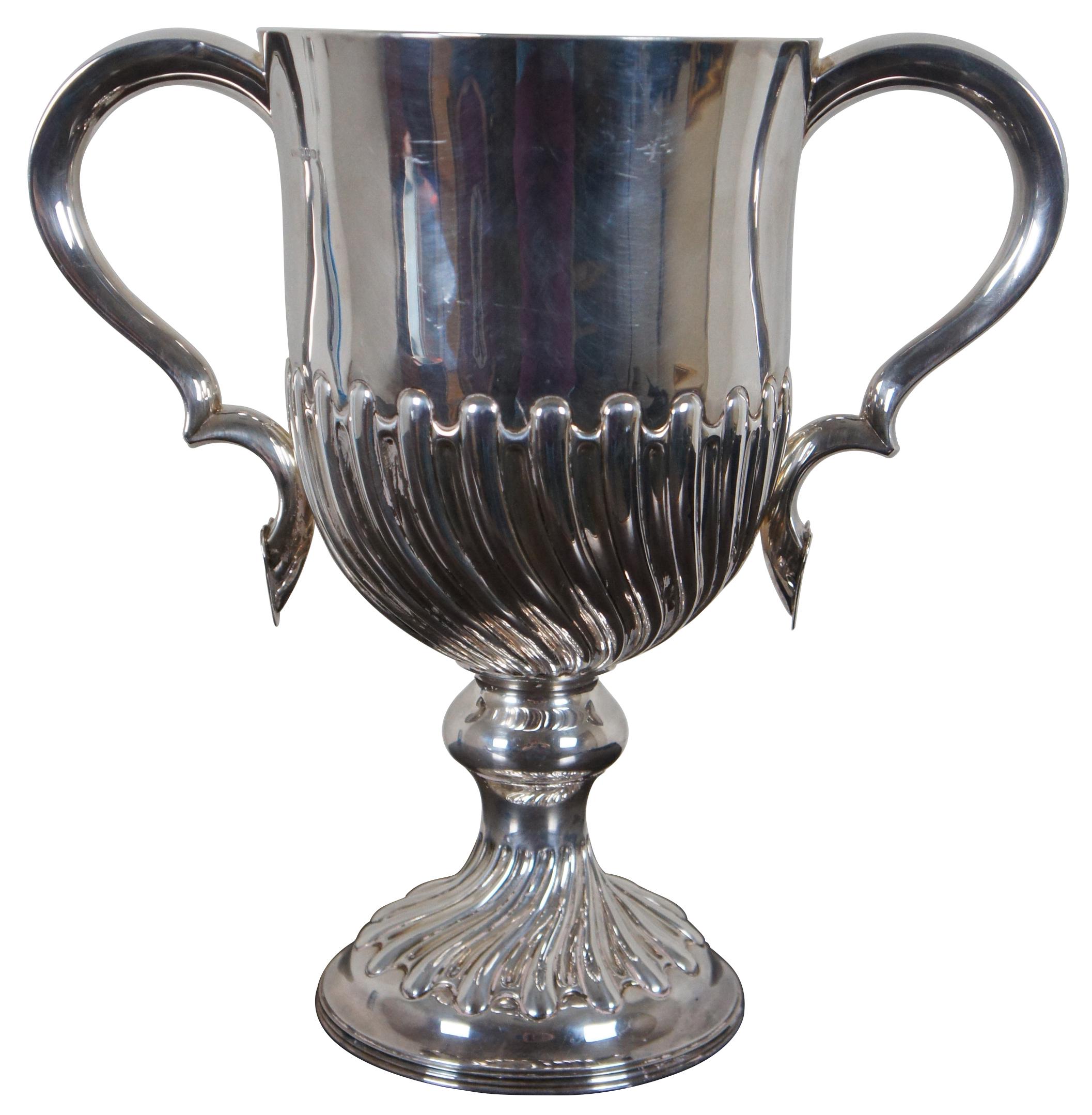 Large antique trophy shaped silver ice / champagne bucket, vase or trophy presentation cup by Harry Atkin.  Beautifully chased with gadrooning design along base and lower side of cup.  Features thick contoured handles leading to a heart pendant.