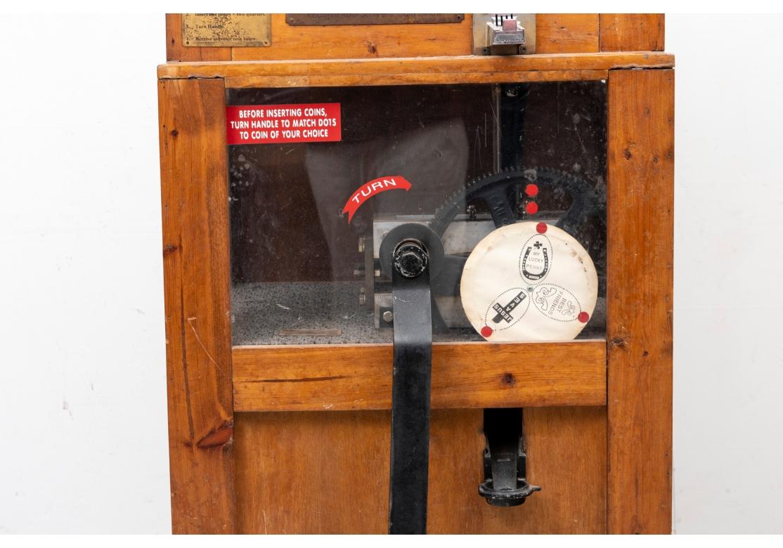 A Historical artifact once used in the HBO series Boardwalk Empire. Maple cabinet with brass plaques and painted iron mechanism. Costing two quarters and a penny to play. Not tested for working condition. 
H. 60 1/2