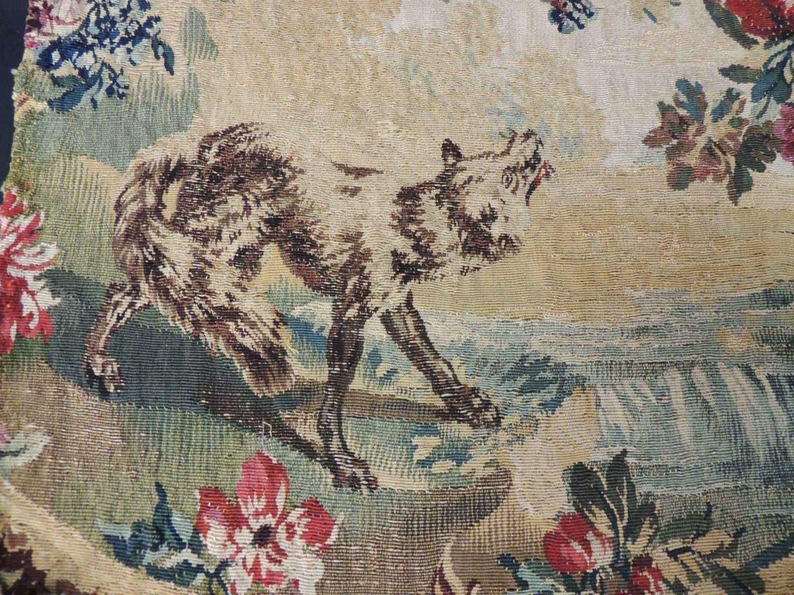 Antique Aubusson Oval Tapestry Fragment.
Woven tapestry depicting wolf trying to get grapes from tree.
Colorful tapestry in shades of blue, red, green, gold, brow and pink.
Ideal for a pillow or chair backing.
Sold as is.
Size: 16