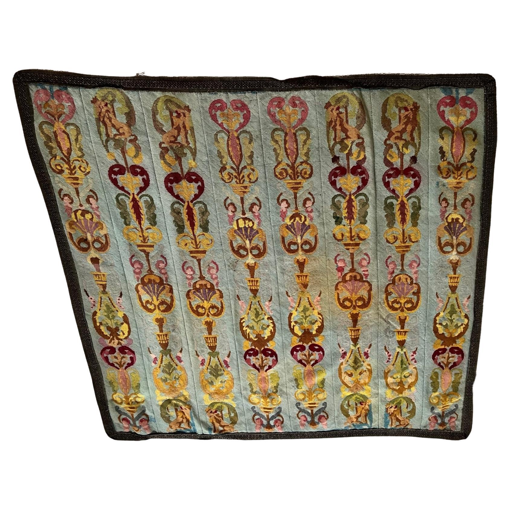 An unusual aubusson-style tapestry wall hanging comprising 8 panels with recurring lion, urn and floral motifs on a pale blue field with a passementeire border and cotton backing. While the colors of the tapestry have faded somewhat over time, the