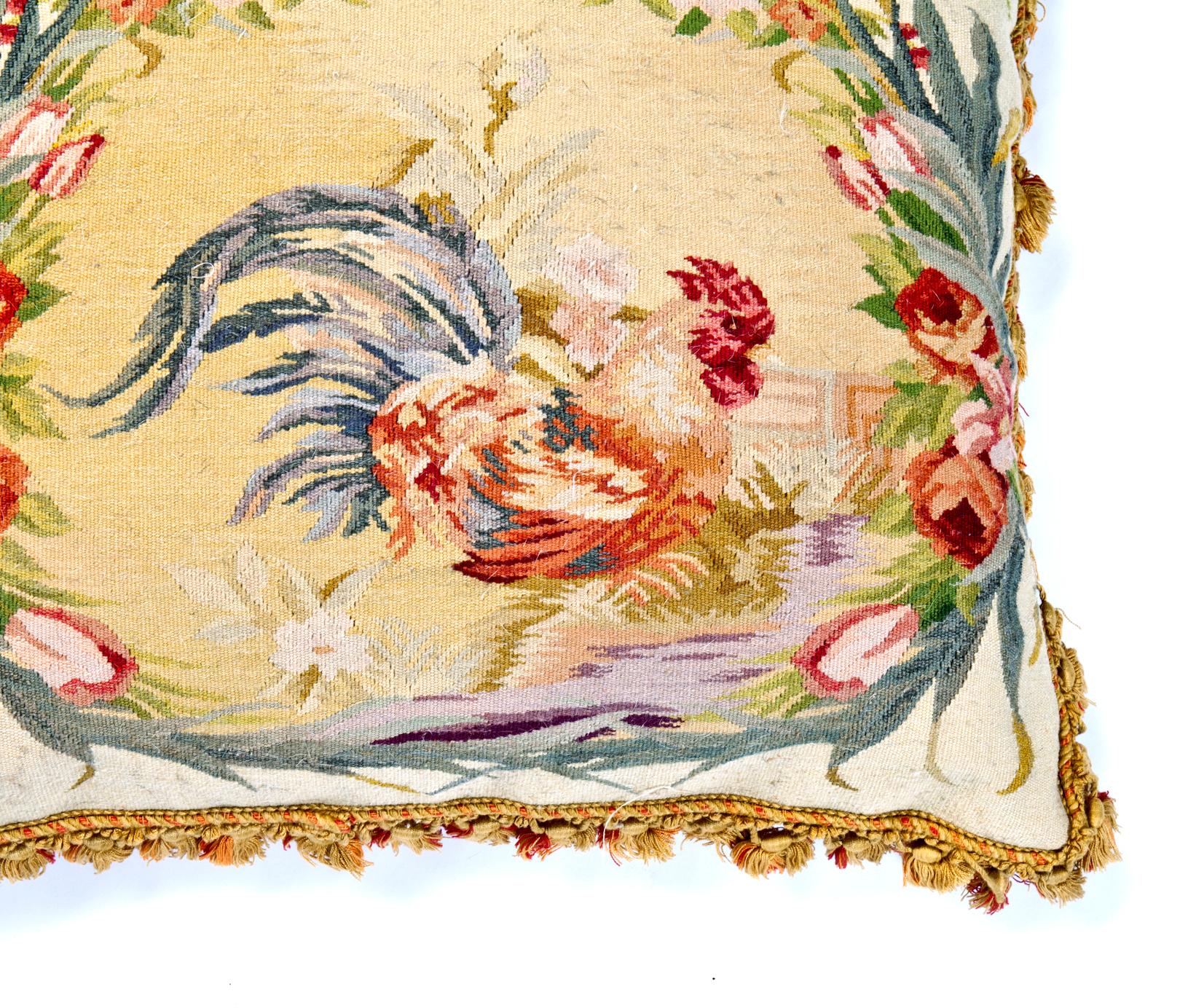 Handwoven French Aubusson tapestry pillow depicting rooster & flowers. Velvet back with zipper closure. Fringe trim. Feather & down insert; cotton interior cover. Some age to the velvet backing & fringe.