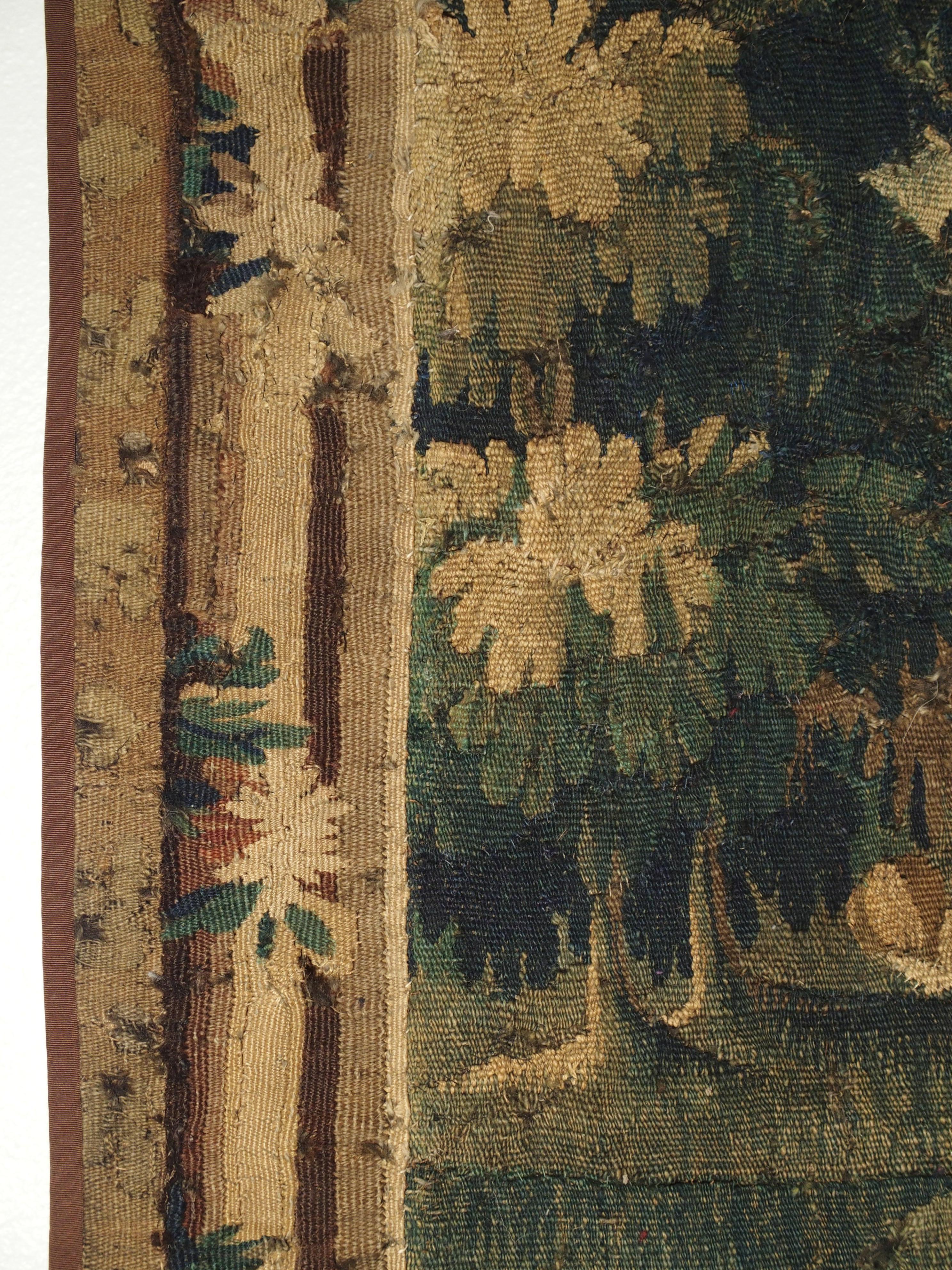 From northern France, this verdure tapestry fragment is in the shape of a portiere and dates to the 1600s. It would have covered a doorway from one room to the other. Tapestries were used in chateaux for their beauty as well as for warmth. This