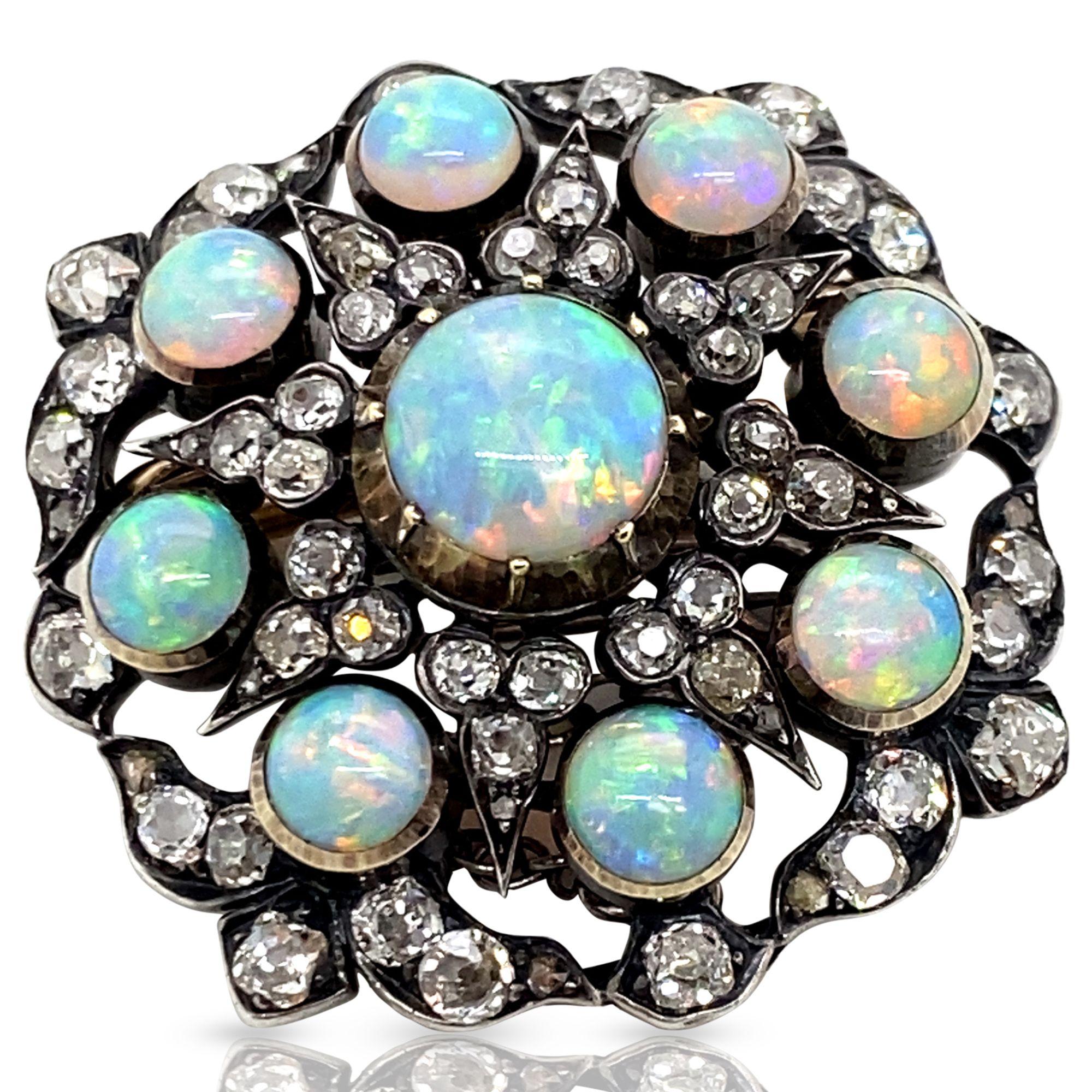 This brooch is absolutely captivating! The magnificence of Australian opal is really on display in this gorgeous antique pin. Featuring nine solid white crystal opal cabochons surrounded with the sparkle of old cut diamonds - can it get any better?
