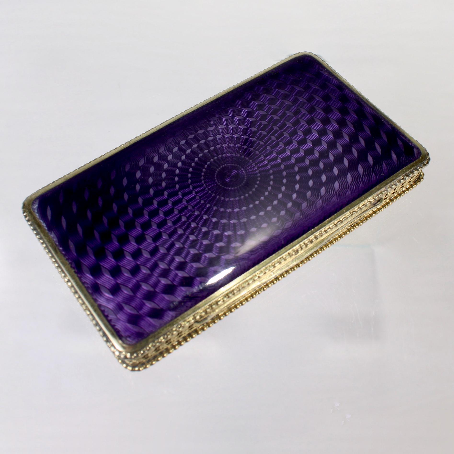 A fine, antique Austrian coin silver compact or covered box.

In gilt 900 fine silver.

Decorated with purple guilloche enamel to both top and bottom.

Together with its original leather with case. 

Simply a lovely little box!

Date:
Late 19th or