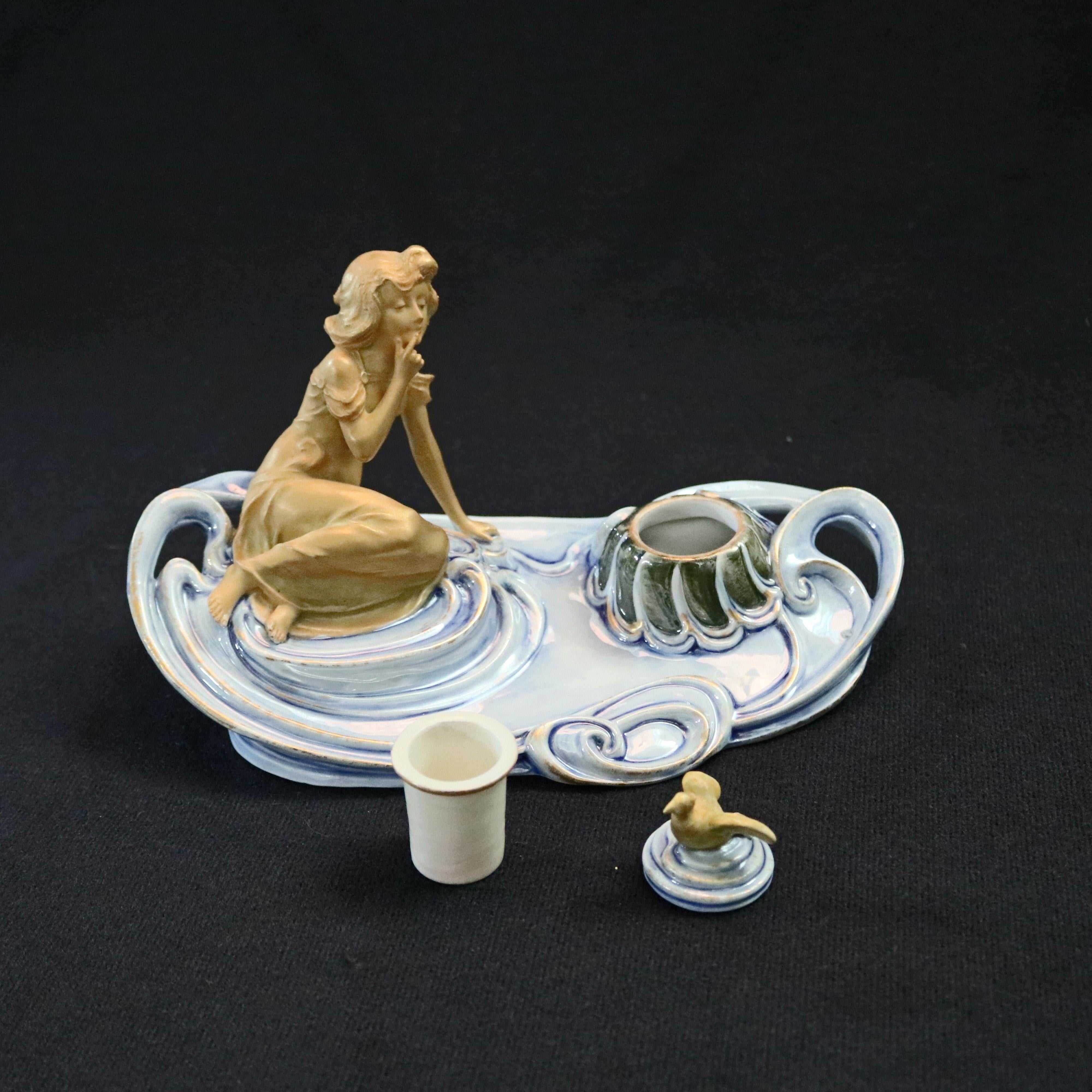 An antique Austrian Art Nouveau figural amphora porcelain inkwell offers grouping of young woman seated on water form tray with lidded inkwell having bird form finial, Turn Wein Crown Mark stamped on base, circa 1920

Measures - 4.5