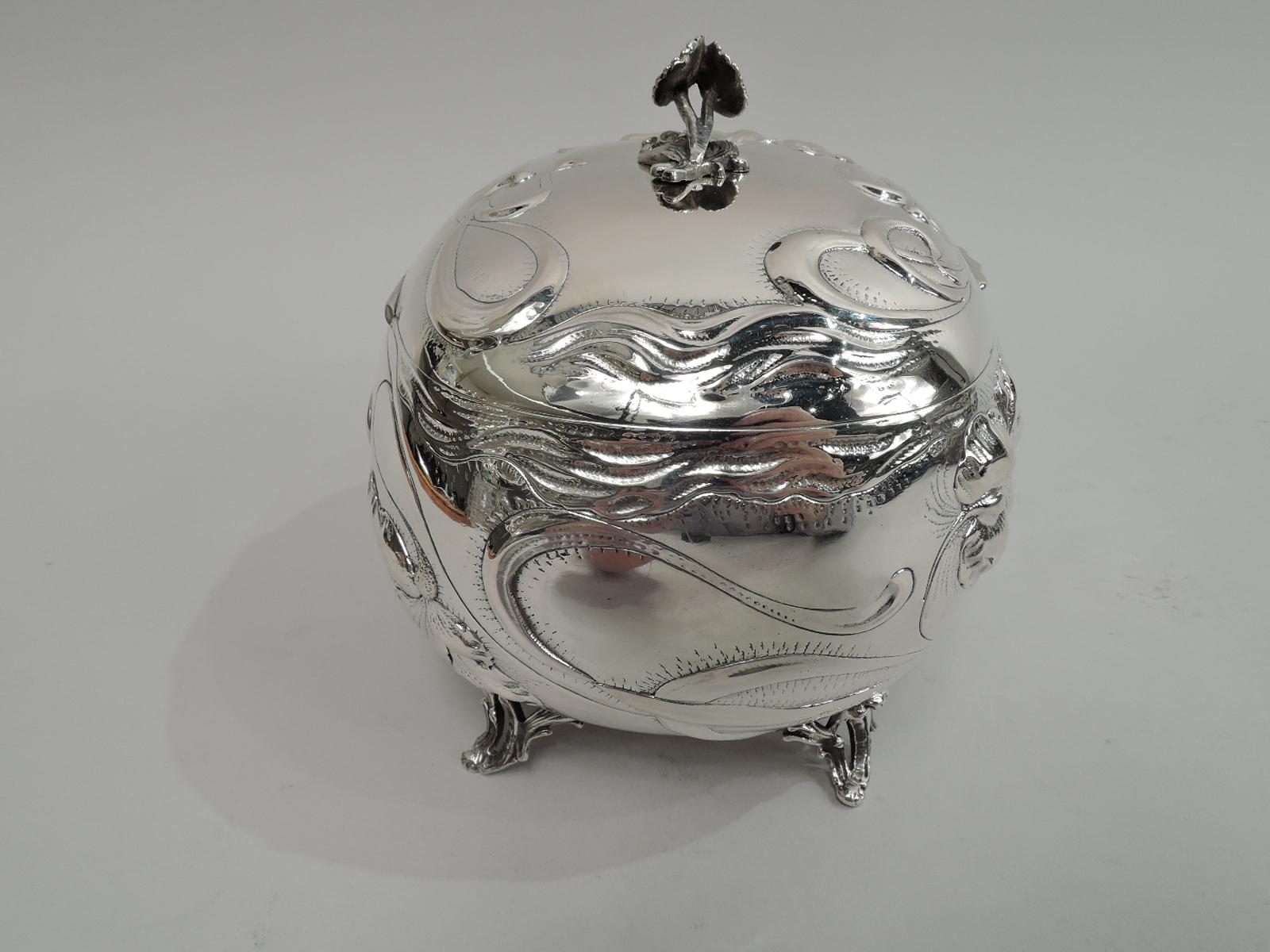 Turn-of-the-century Austrian 800 silver keepsake box. Rectangular with curved sides and open scrolled corner supports. Cover hinged with scalloped tab and flower finial. Chased ornament: Loose and floaty flowers as well as whiplash tendrils and wavy