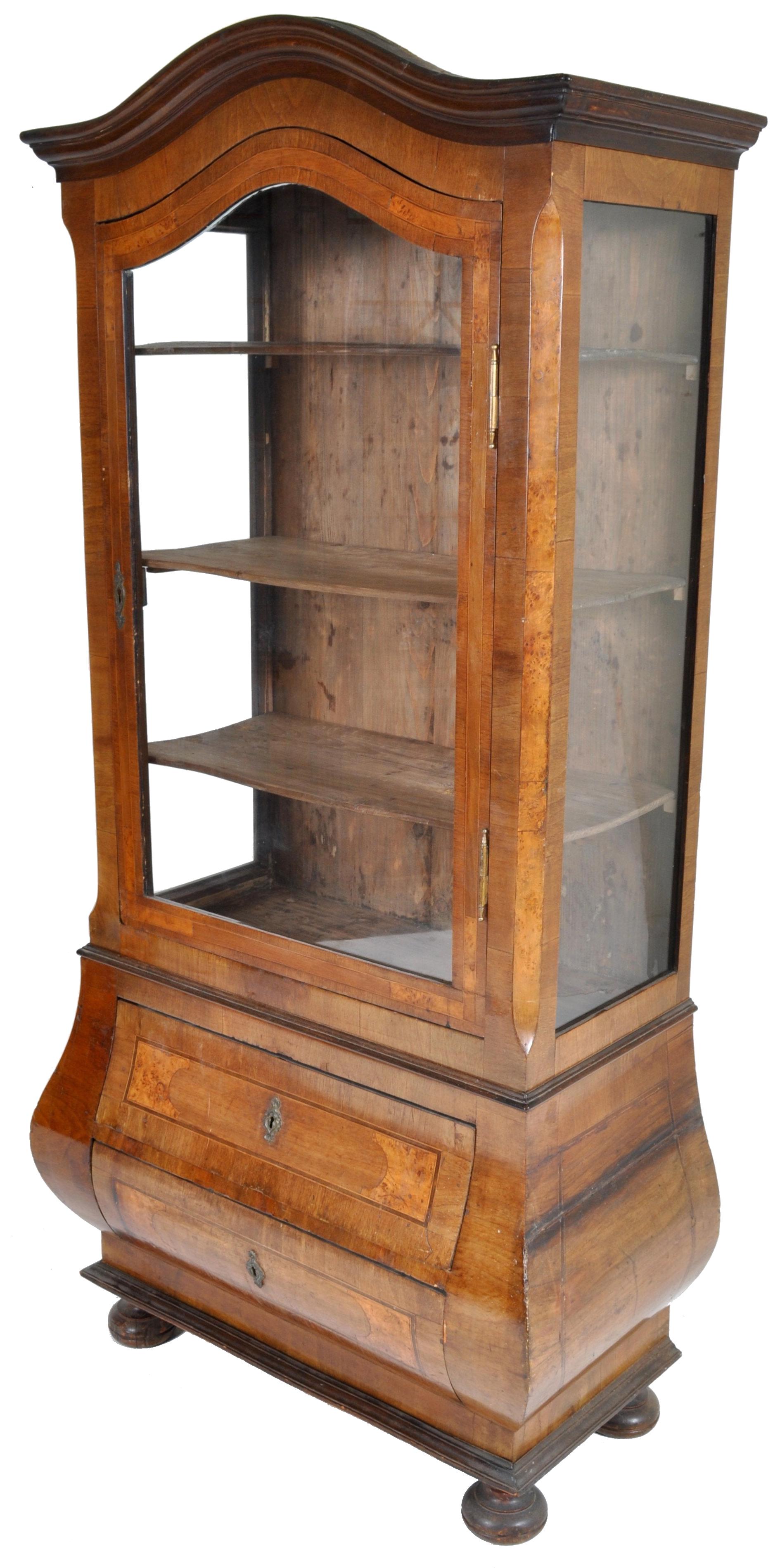 Antique Austrian Biedermeier bombe shaped China cabinet/hutch, circa 1840 having an arch shaped top with a single door below enclosing three shelves, the base of bombe shape with two drawers standing on compressed bun feet.