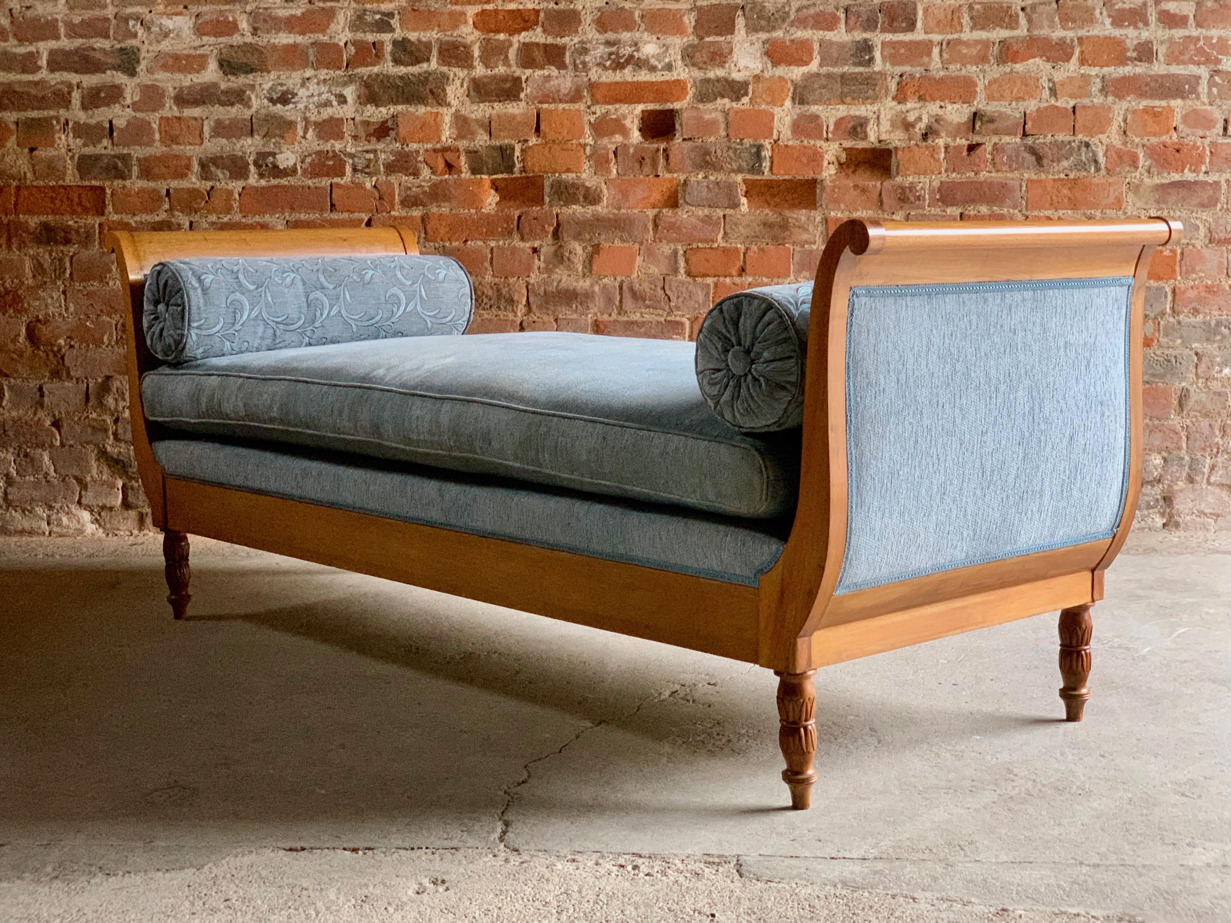 Antique Austrian Biedermeier style daybed chaise lounge, circa 1910.

A beautiful Austrian Biedermeier style daybed early twentieth century circa 1910 , with scrolling ends, upholstered in blue fabric, with two bolster cushions and one loose