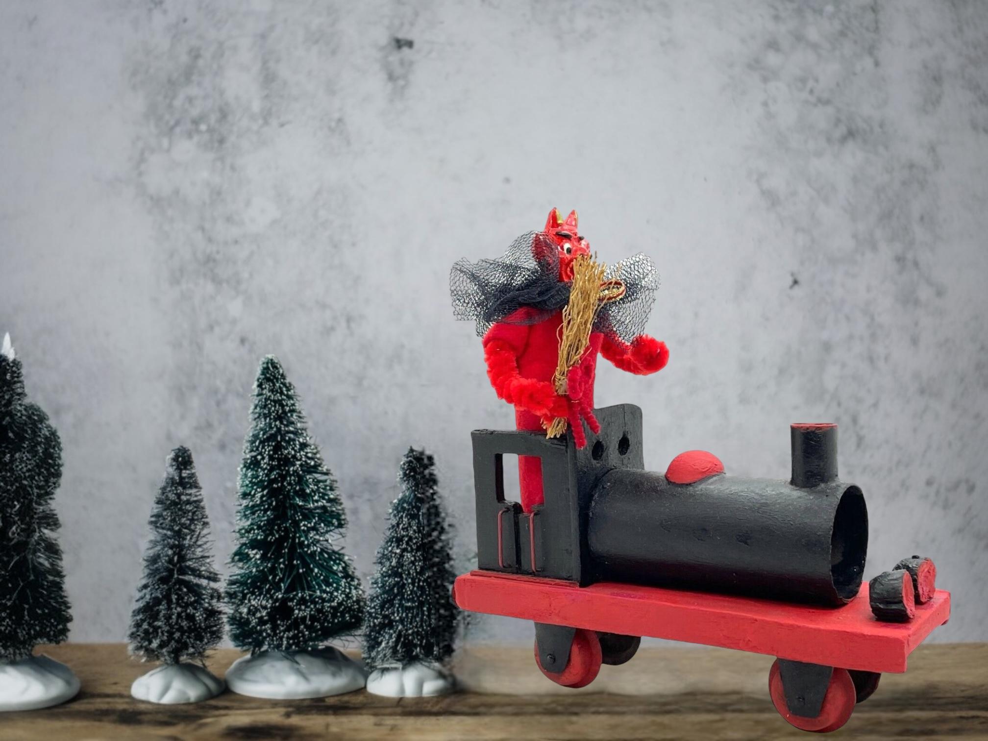 This unique Christmas figurine from Austria features a handmade figurine of the Christmas character Krampus, Belsnickel's companion. The vintage piece dates from the 1920s or older and features intricate handwork and an antique finish. Given the