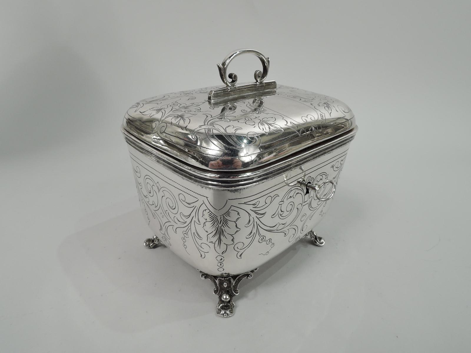 Austrian 800 silver casket, ca 1910. Rectangular with gently tapering sides and curved corners. Cover hinged and raised with hinged and capped c-scroll handle. Engraved leafing scrollwork, and scrolled oval cartouche (vacant) on cover top. Rests on