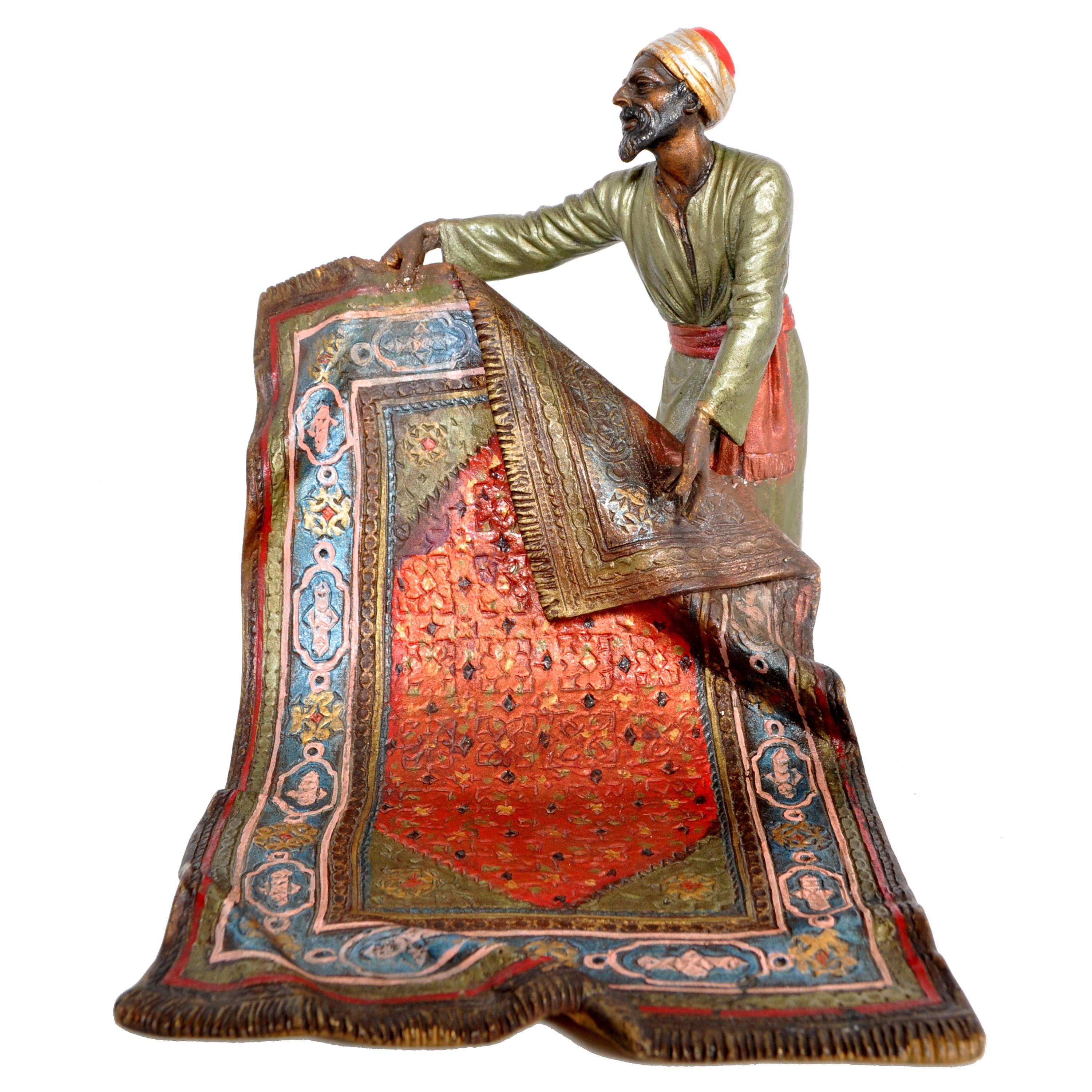A good, antique, cold-painted bronze figure of an Arab carpet seller, by Franz Bergmann, circa 1900.
The figure is displayed standing and presenting a Persian oriental carpet , the figure retains all of the cold-painted polychrome decoration. The