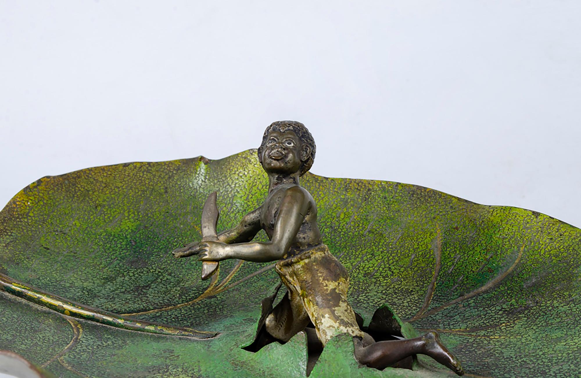 Antique Austrian Cold-Painted Bronze
Boy on a leaf, 20th century

Measures:
44 centimeters long
20,5 centimeters depth
11 centimeters high

This antique cast and cold-painted bronze sculpture is unsigned but presumed to have been made in Austria in