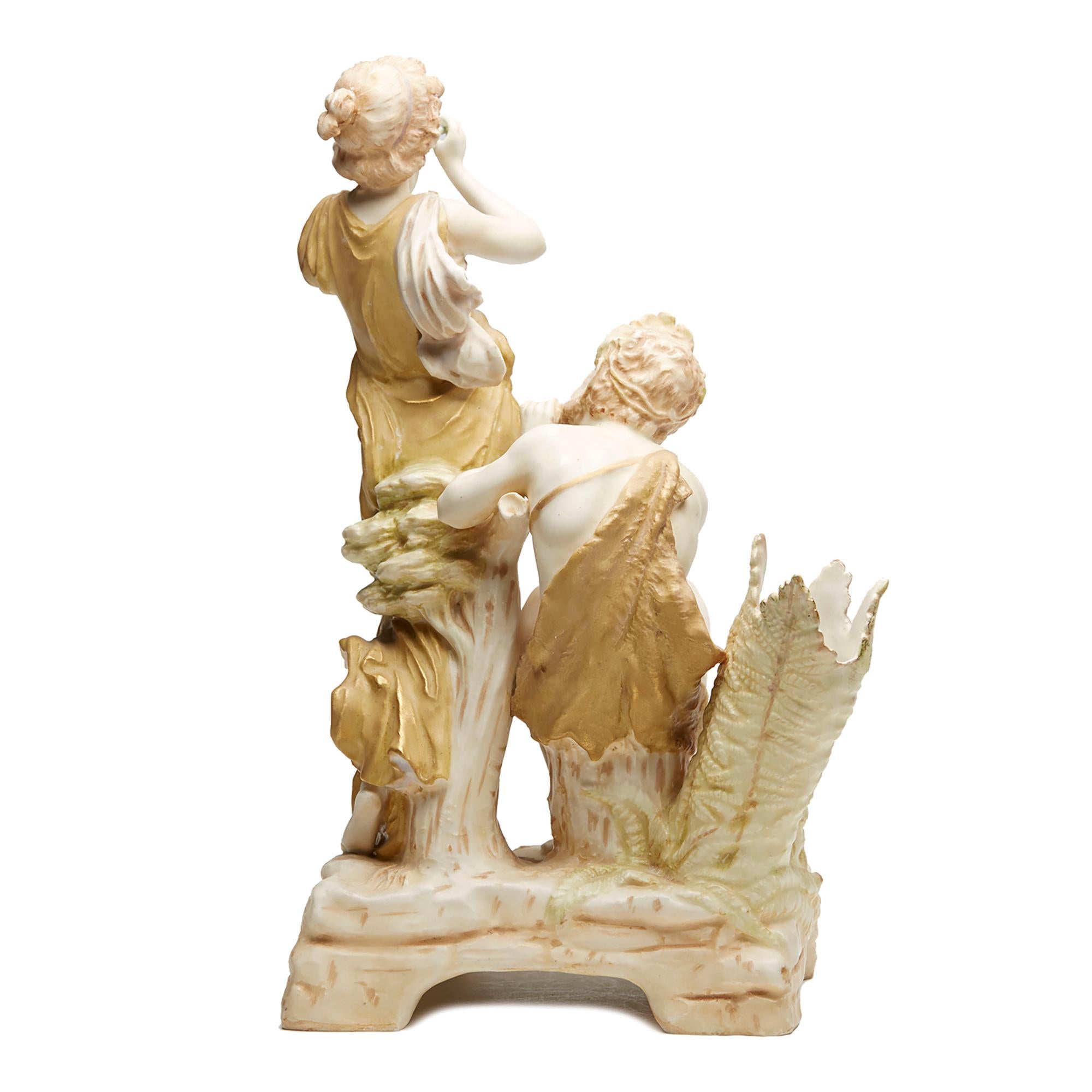 A stunning antique Austrian Royal Vienna musician figural spill vase by Ernst Wahliss. This finely made group comprises of a young standing maiden and seated man both scantily dressed playing a flute and pipes on a raised four foot rectangular base.