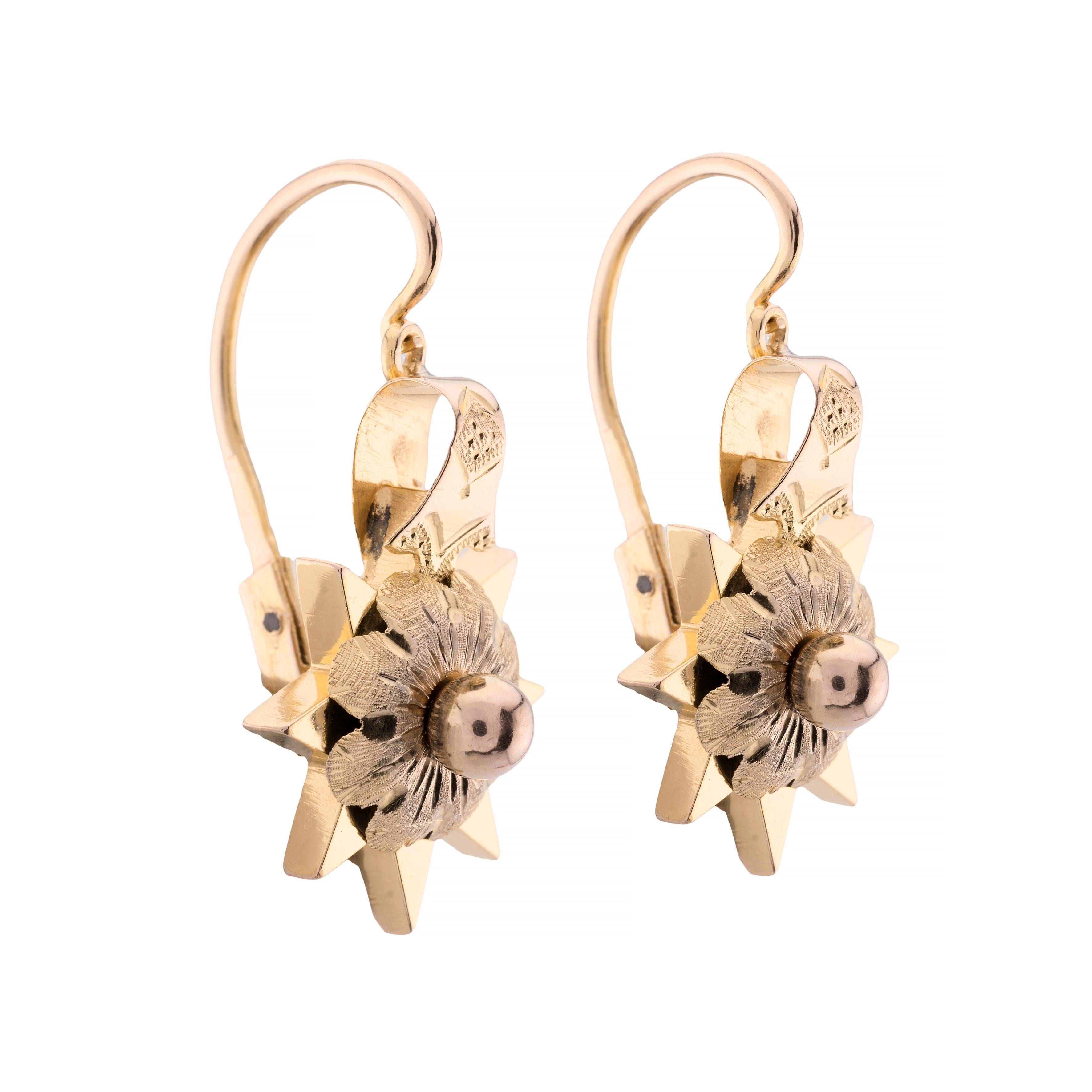 Aston Estate Jewelry Presents:

A pair of exquisite Victorian drop earrings from 1870. 

Crafted in Austria, these earrings feature a striking starburst design. Made from 14k yellow gold, the intricate detailing includes a central floral motif