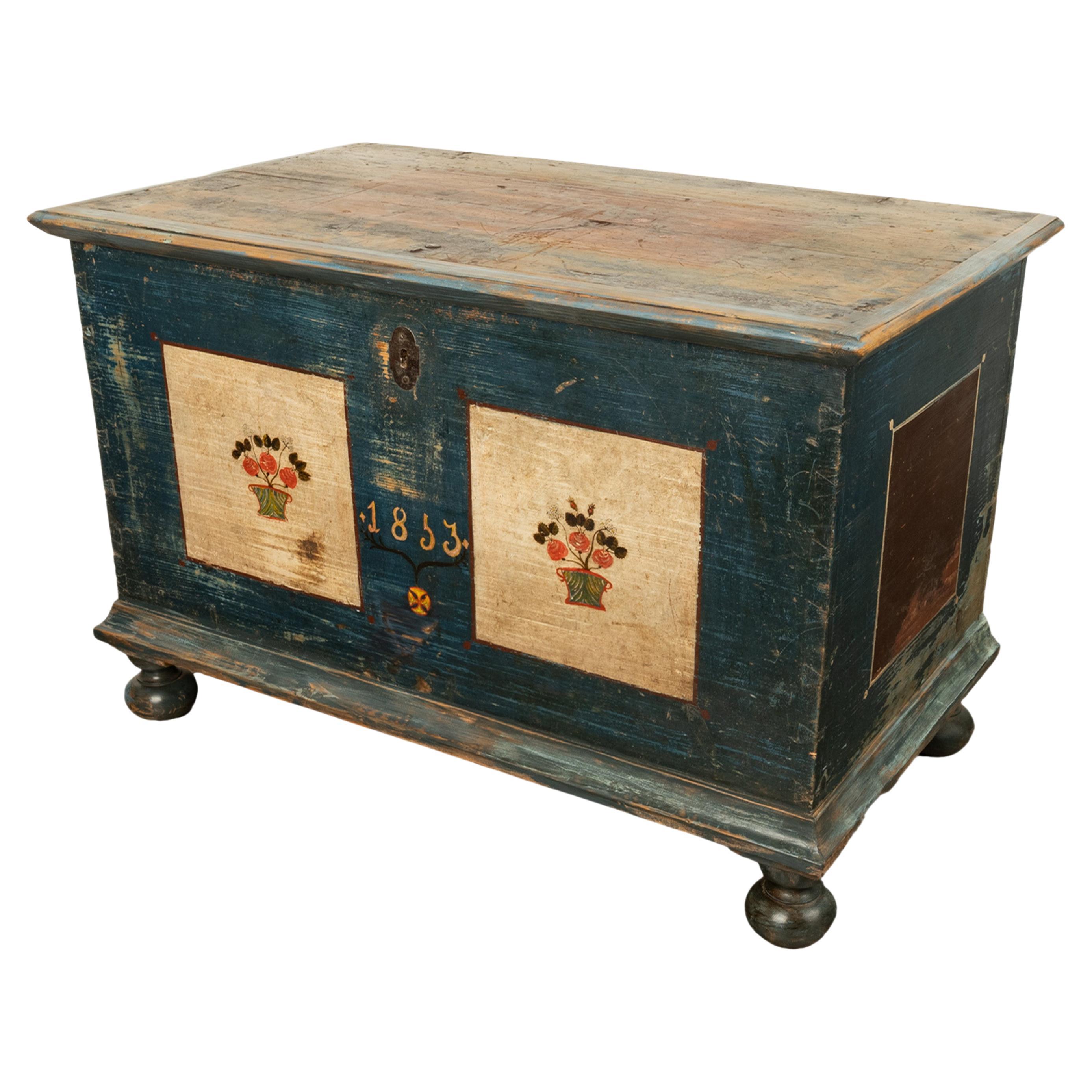 A good antique Austrian Folk Art hand-painted pine marriage chest, dated 1853.
The chest with a hinged lid with the original iron snipe hinges, enclosing a large storage area with a lidded 'candle' till to the left hand side. 
The chest retains the