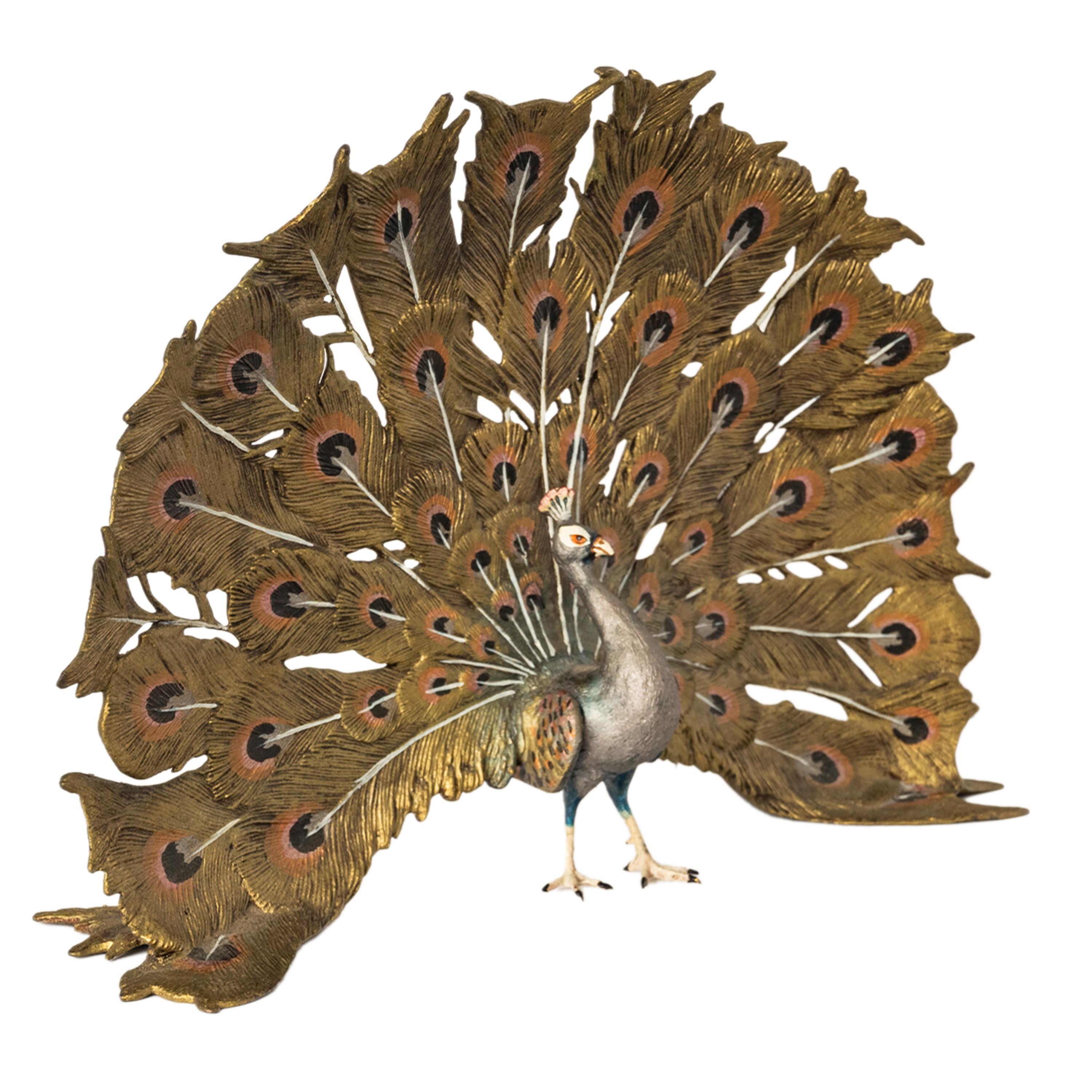 A fine antique Austrian Art Nouveau coldpainted bronze sculpture of a peacock by Franz Bergman, Vienna, circa 1920. 
The bronze depicts a remarkably lifelike peacock in full display, its vibrant, iridescent feathers in a fanned train with hues of