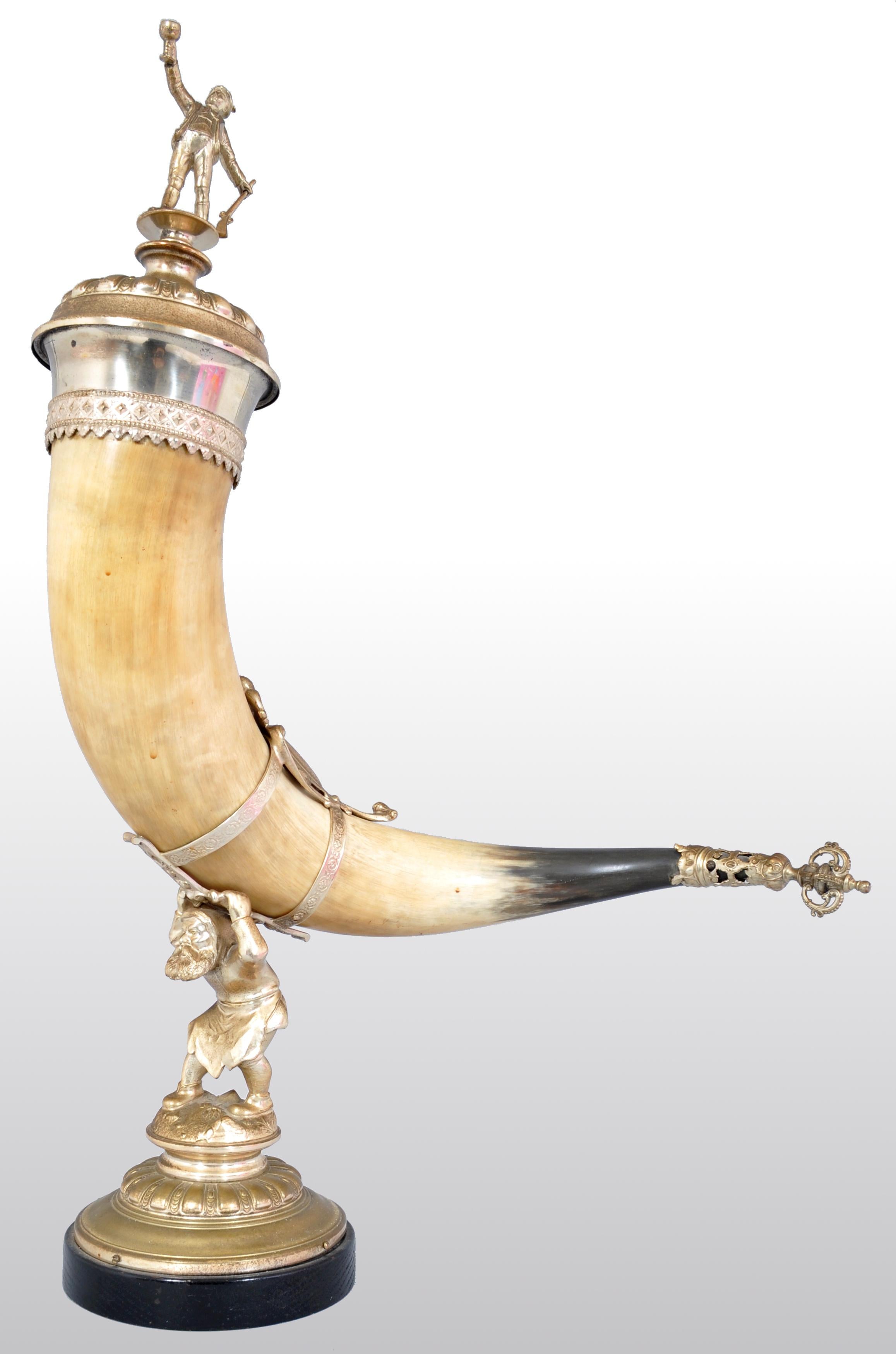 Antique Austrian gilded bronze hunting horn/cornucopia, circa 1880. The horn having an Austrian Gentleman finial depicting the hunter with his rifle and raising his glass aloft. The horn standing on a base cast as a fairy tale gnome, the end of the