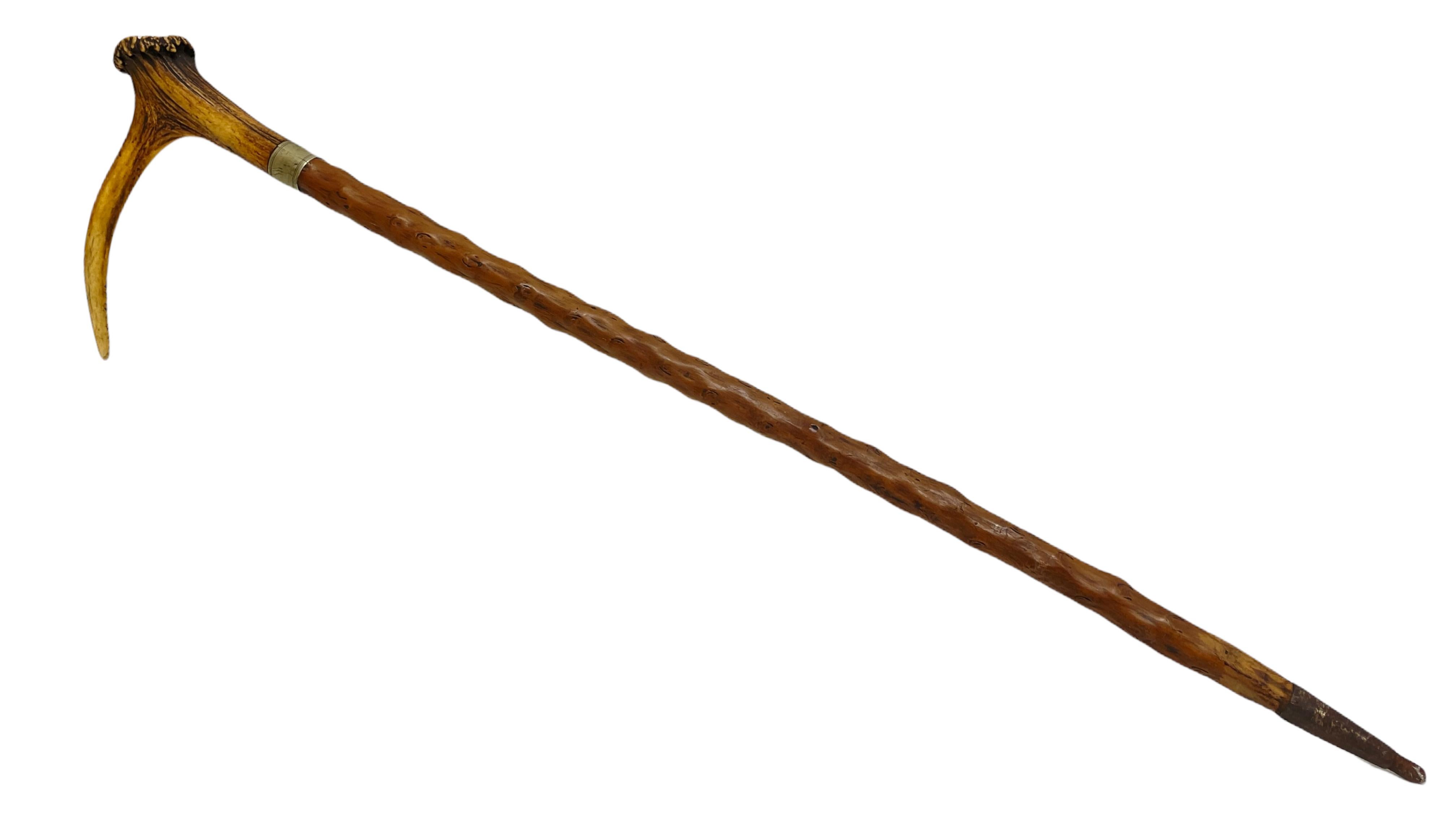 Unique Austrian hunting walking cane from the early 20th century - the walking cane is handmade of blackthorn wood, featuring a deer antler handle with silver chiselled collar.