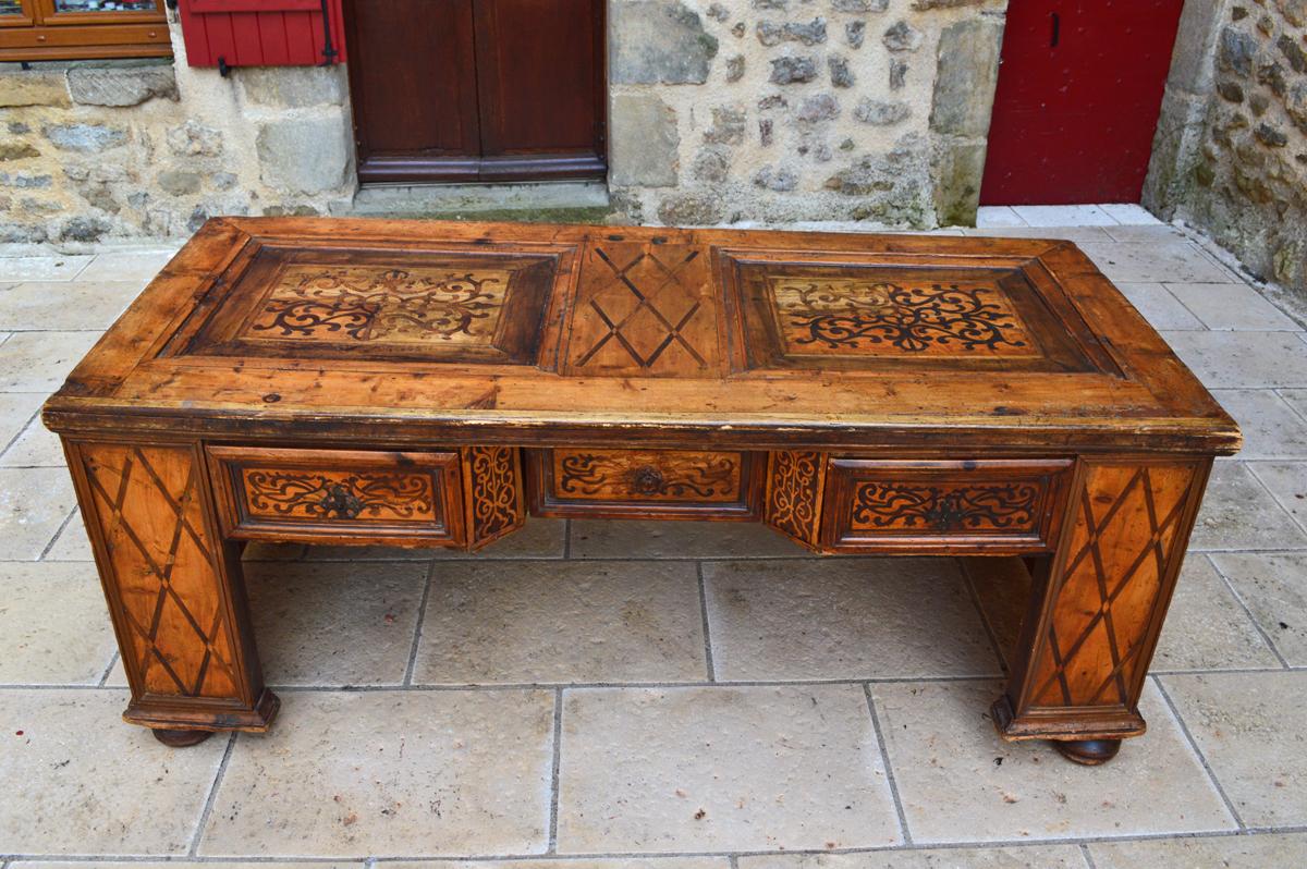 - Huge 17th century trunk crafted into a minister's desk in the 19th century 
- Paneled and inlaid construction 
- Decorated with colonnades 
- Romanesque arches 
- Three drawers and two locks.

Good condition for is age, missing handle on