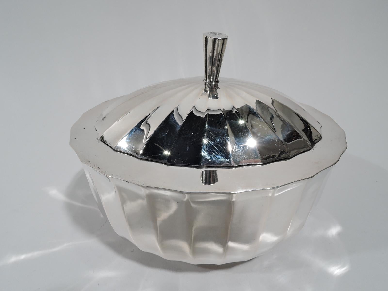 Austrian Modern Classical 800 silver box, ca 1925. Oval and faceted with wide and flat plain shoulder. Cover hinged and domed with fluted patera and tapering and lobed finial. Post-1921 marks and no. 94911. Weight: 9 troy ounces.