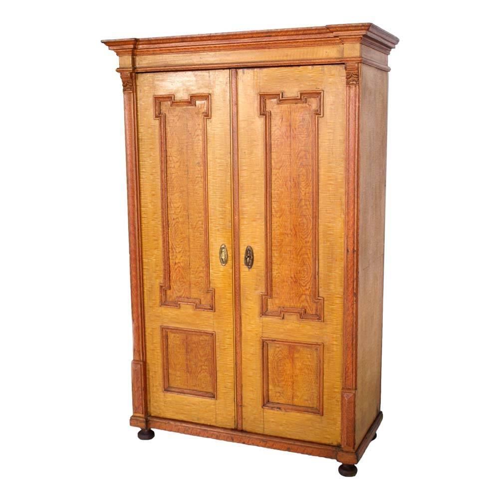 Mid-19th century neoclassic wardrobe cupboard in massive wood lacquered faux wood; with columns and hand carved capitals.
Wardrobe restored leaving the signs of aging in precious lacquer manuals.
Polished to wax.
Great for any combination and