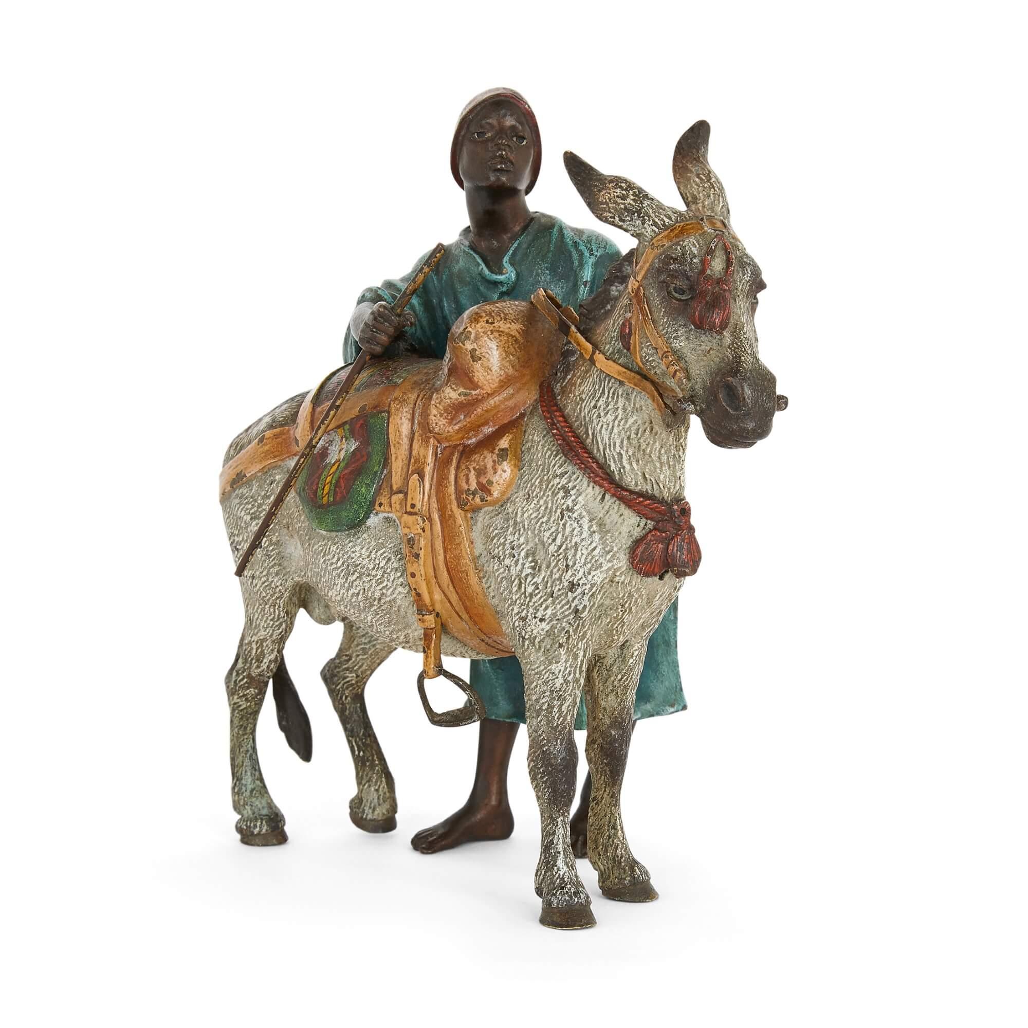 Antique Austrian orientalist bronze donkey by Bergman
Austrian, c. 1910
Measures: Height 13cm, width 13cm, depth 7cm

This beautiful cold-painted bronze by Franz Xaver Bergman depicts a donkey and its rider, who stands beside. The bronze group