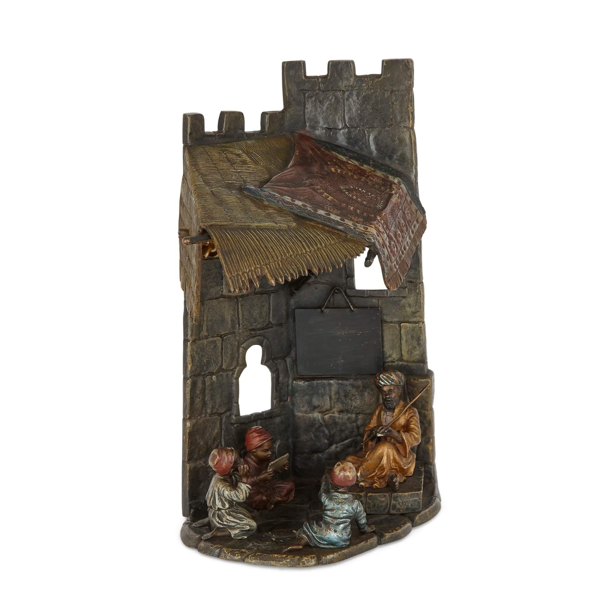 Antique Austrian Orientalist cold-painted bronze lamp 
Austrian, Early 20th Century
Height 25cm, width 16cm, depth 12cm

Depicting a charming school scene, this Orientalist lamp wrought in the traditional Viennese manner from cold-painted bronze is