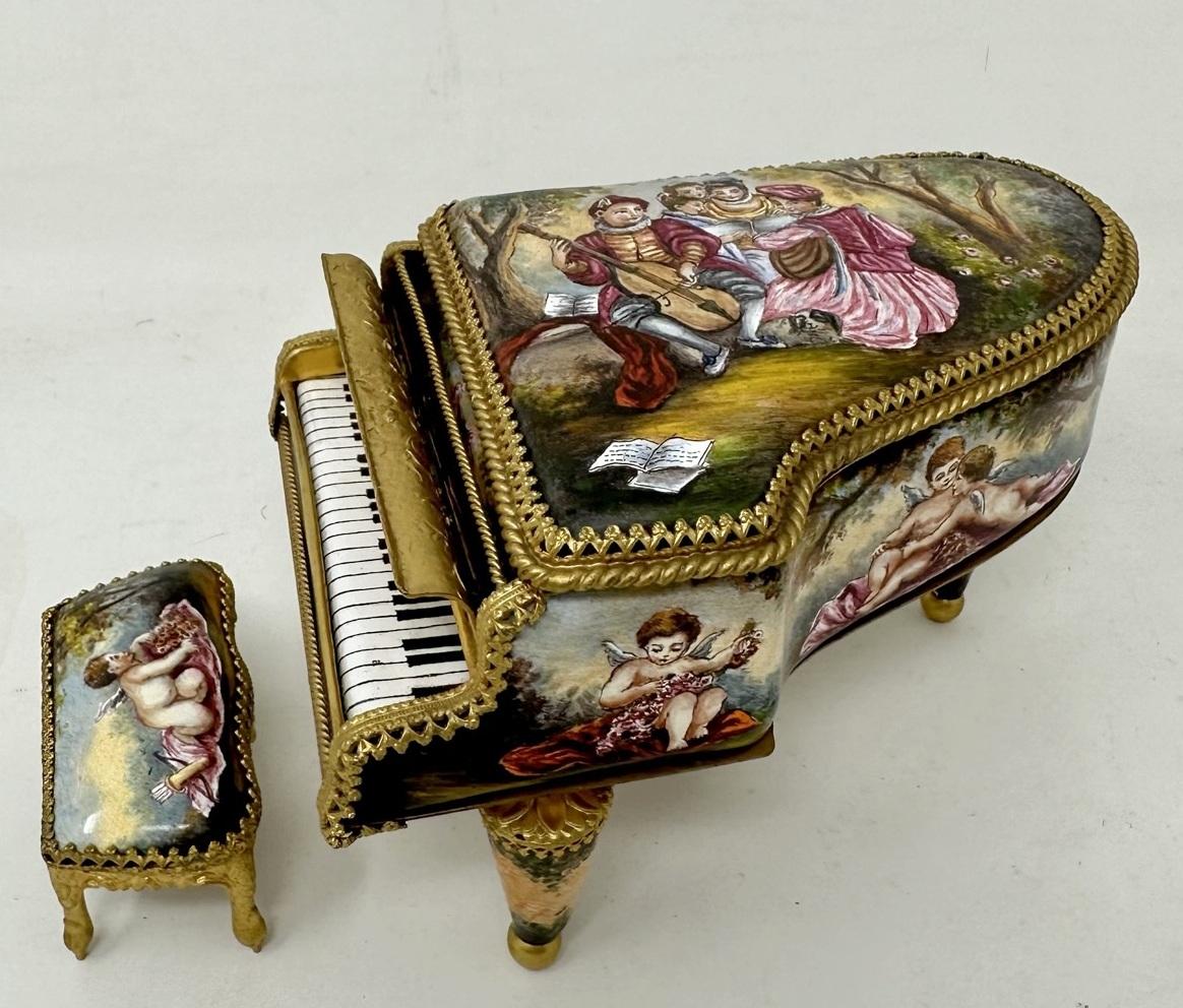 A Rare Antique Hand Painted Viennese Enamel Musical Casket in the form of a miniature Grand Piano, to include its original rectangular stool, last quarter of the 19th century 

Constructed in Gilt Bronze and Austrian Enamel Porcelain. The main