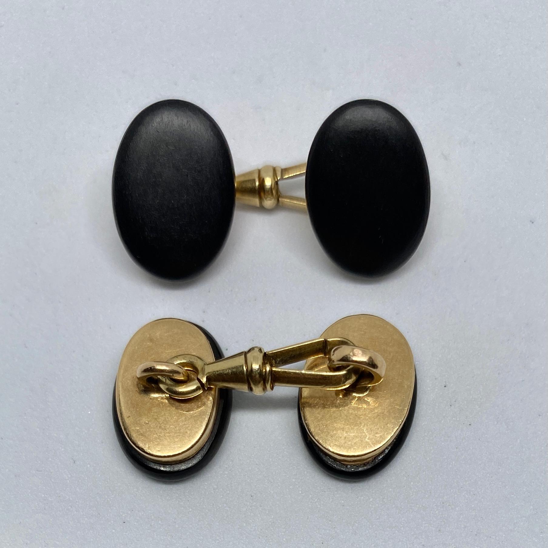 A superb pair of double-sided cufflinks handmade in Austria in the early 20th Century. 

The cufflinks are rendered in solid 14K yellow gold and feature four oval discs in rich, black ebony. Each pair is joined by a spring loop connector, also in