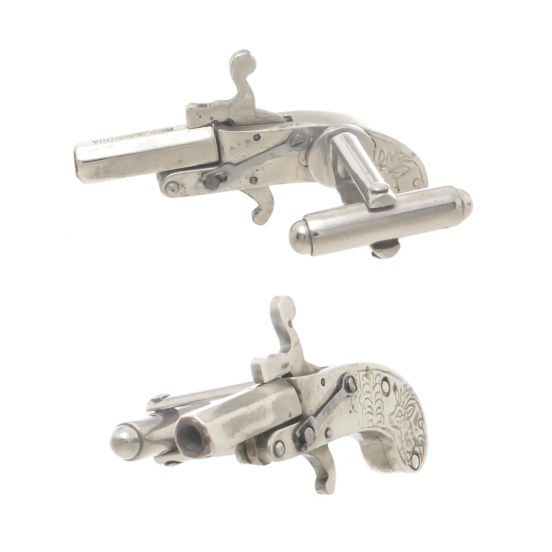 Circa 1930s Austrian Miniature Pistol Cufflinks, Nickle metal, measuring 1 1/2 inch in length, all mechanics on these are fully functional as these originally fired a cap.
