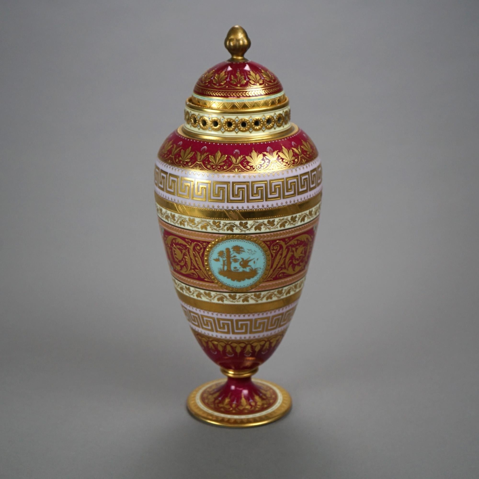 An antique Austrian Royal Vienna covered urn offers highly decorated porcelain construction with portrait reserve having Classical Greek woman and cherub, gilt highlights throughout, blue beehive mark on base as photographed, c1890

Measures-