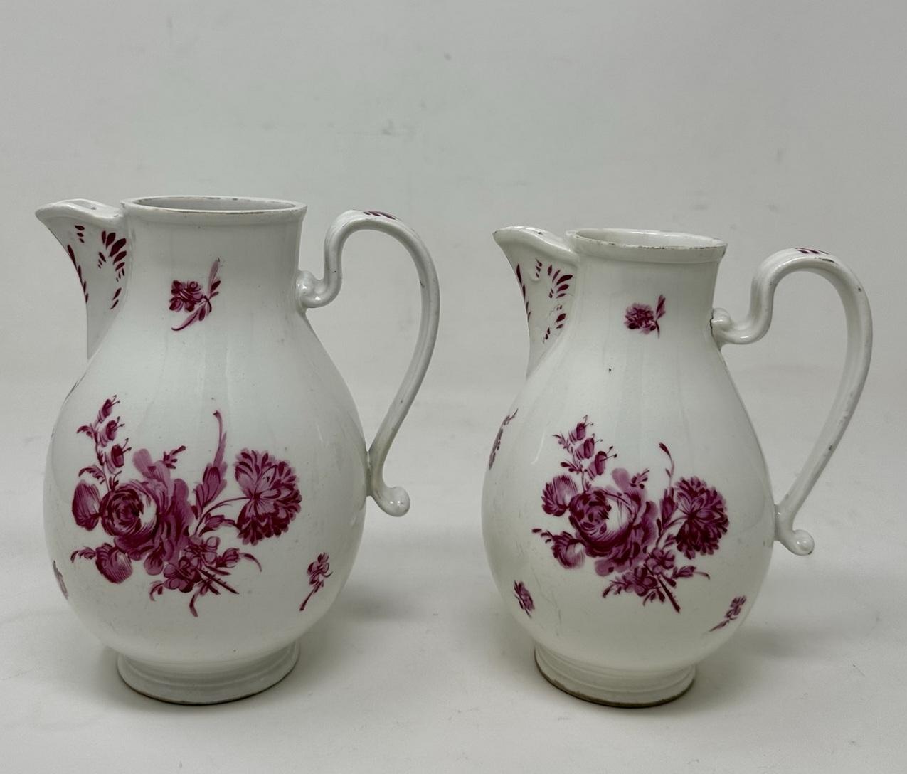 An Extremely rare pair of early Royal Vienna Porcelain Hand decorated Milk and Cream Pitchers or Jugs of medium proportion and outstanding workmanship, both of traditional bulbous outline, each with applied “C” scroll handle. Circa first quarter of