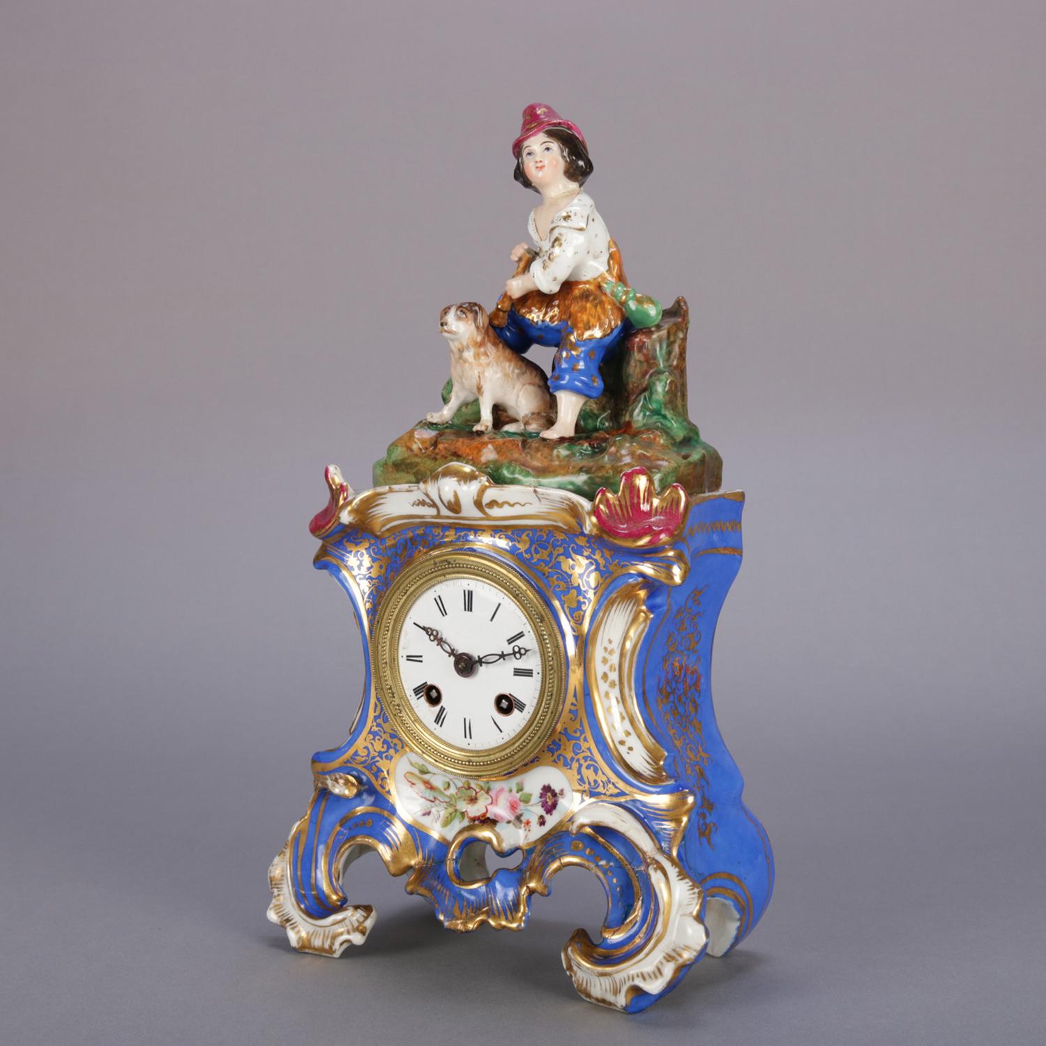 An antique Austrian Royal Vienna School figural Old Paris mantel clock features removable topper with hand painted grouping of peasant boy and his dog in countryside setting surmounting Rococo style clock case with hand painted floral reserve and