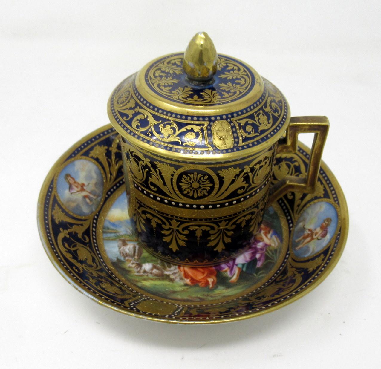 An exceptional Vienna porcelain hand decorated miniature chocolate cup with cover and circular stand of exhibition quality, of cylindrical form with bracket handle, circa last quarter of the 19th century, possibly earlier. 

The circular stand