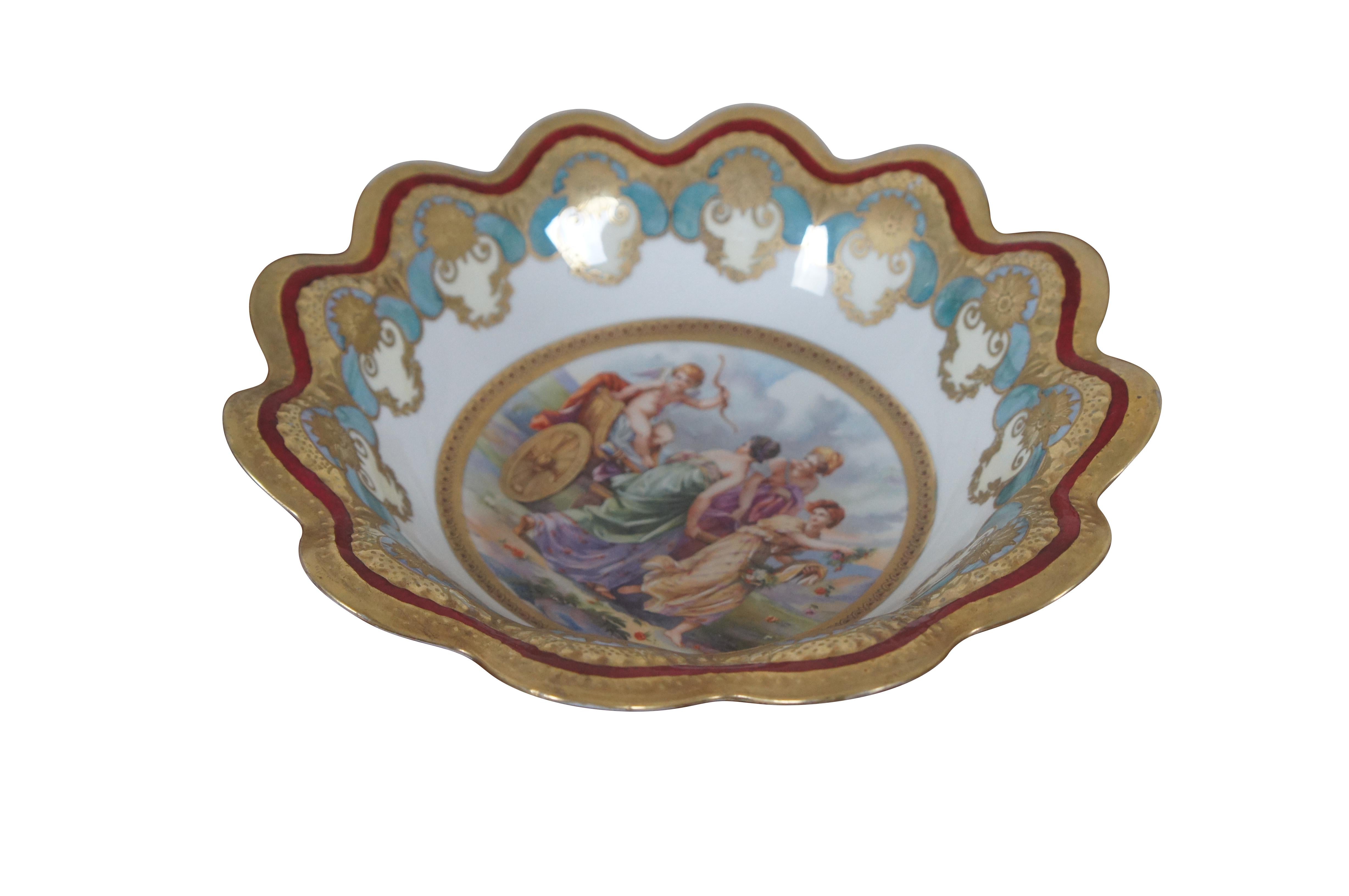 Antique Austrian scalloped porcelain bowl featuring a gold, turquoise and red Neoclassical theme with a Cherub riding in chariot led by three flower girls.

The Stara Role (Altrohlau) pottery works were established in 1810 by Benedict Haßlacher. The