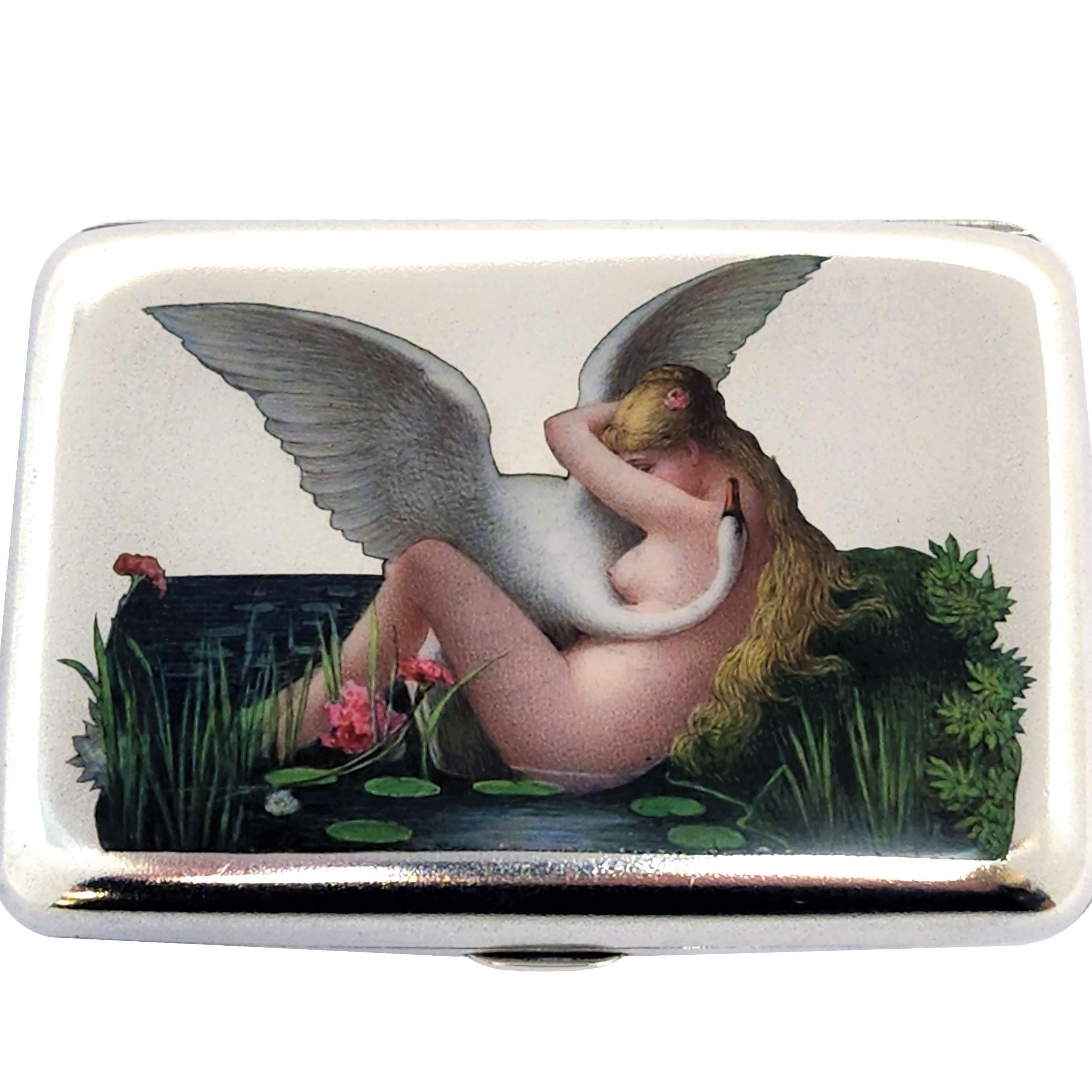 A beautiful Antique Silver & Enamel Cigarette Case with an enamelled image Leda and the Swan on the front cover in beautiful rich enamel colours. The interior of the case is gilded and the back of the case is plain silver. 

The Cigarette Case was