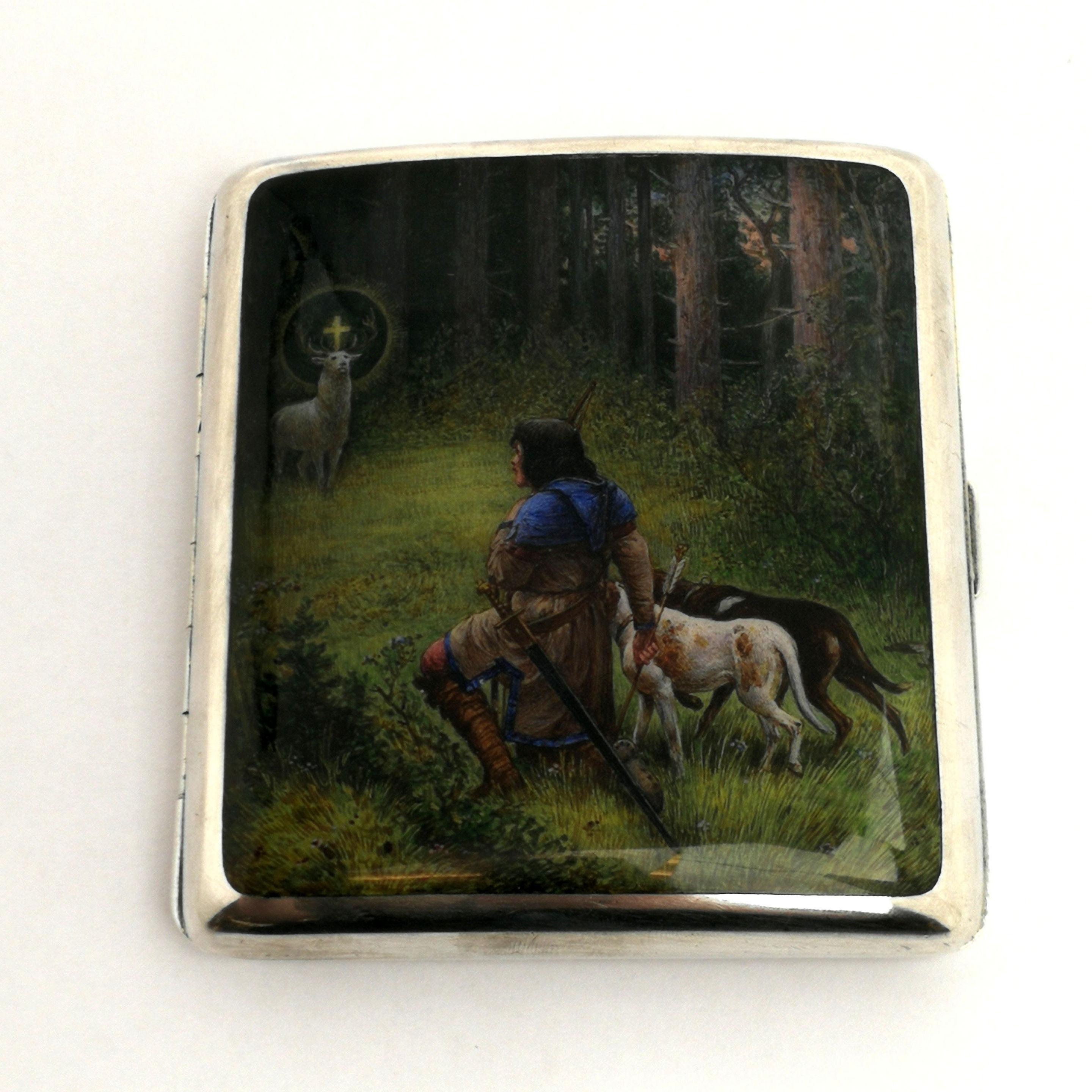 A solid Silver Cigarette Case with a magnificent enamelled image on the front cover. The image is a version of 'The Conversion of Holy Hubertus' by painter Wilhelm Raeuber (1849-1926). This image is created with a careful attention to detail and in
