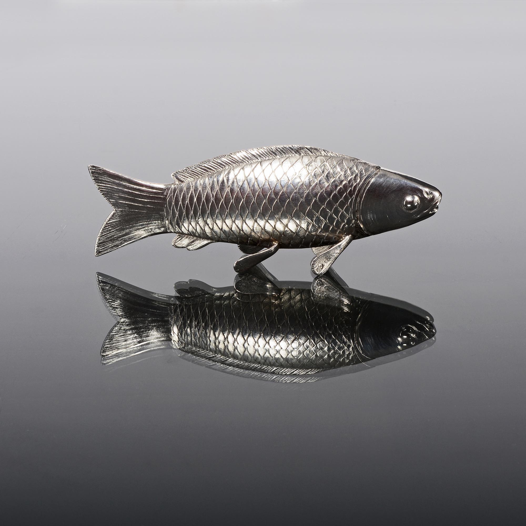 Large silver pepperette in the form of a carp fish. The model features finely detailed and lifelike scales and sits on its four fins. The head is removable to show the pierced shaker top. It has a lovely substantial feel and is a particularly nice