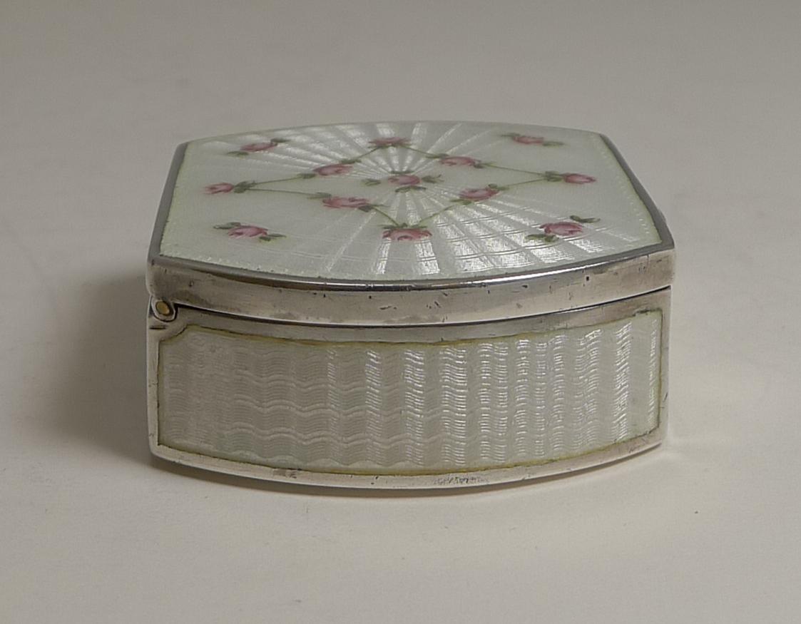 An absolutely stunning large antique Viennese sterling silver pill box made from a hefty gauge of Austrian silver.

All sides are decorated with a white guilloche enamel showcasing the intricate engine turned design below; the top is adorned with