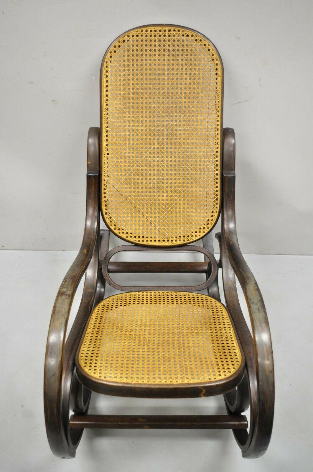 Antique Austrian Thonet bentwood and cane rocker rocking chair. Item features a shapely bentwood frame, cane back and seat, very nice antique, quality craftsmanship. Circa Early 1900s. Measurements: 39