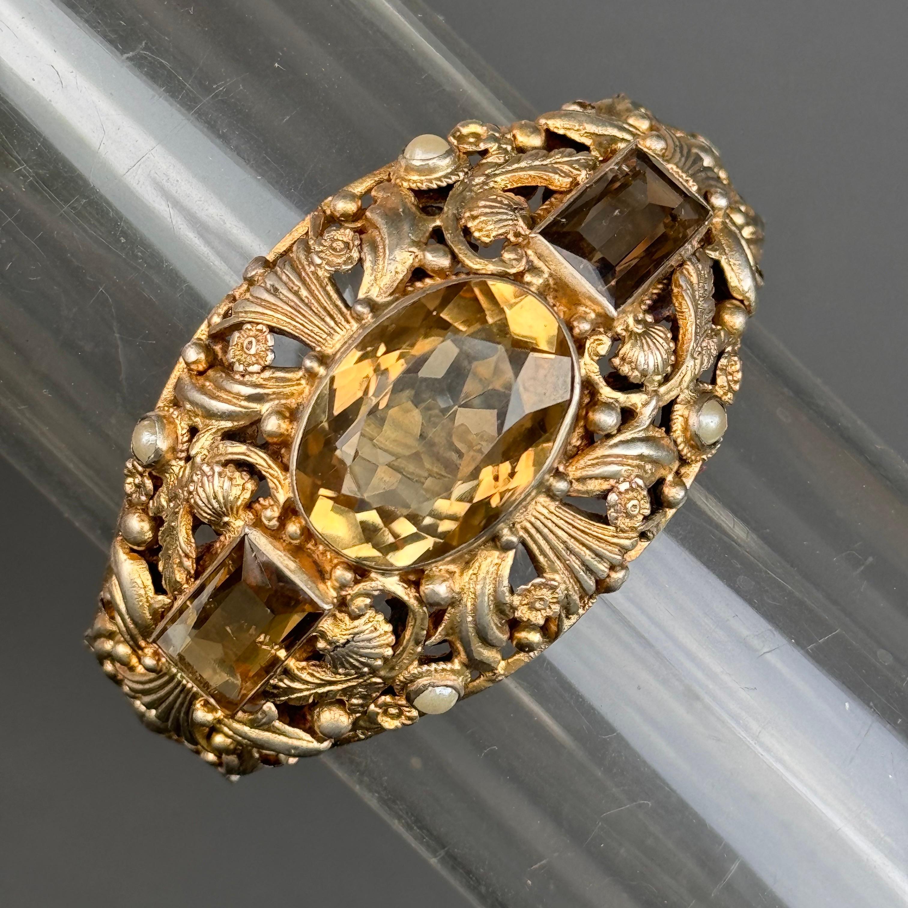 This exquisite antique bracelet showcases the timeless elegance of Austro-Hungarian craftsmanship. Featuring vibrant citrine gemstones set in intricate openwork design , each stone is complemented by delicate pearls that add a touch of