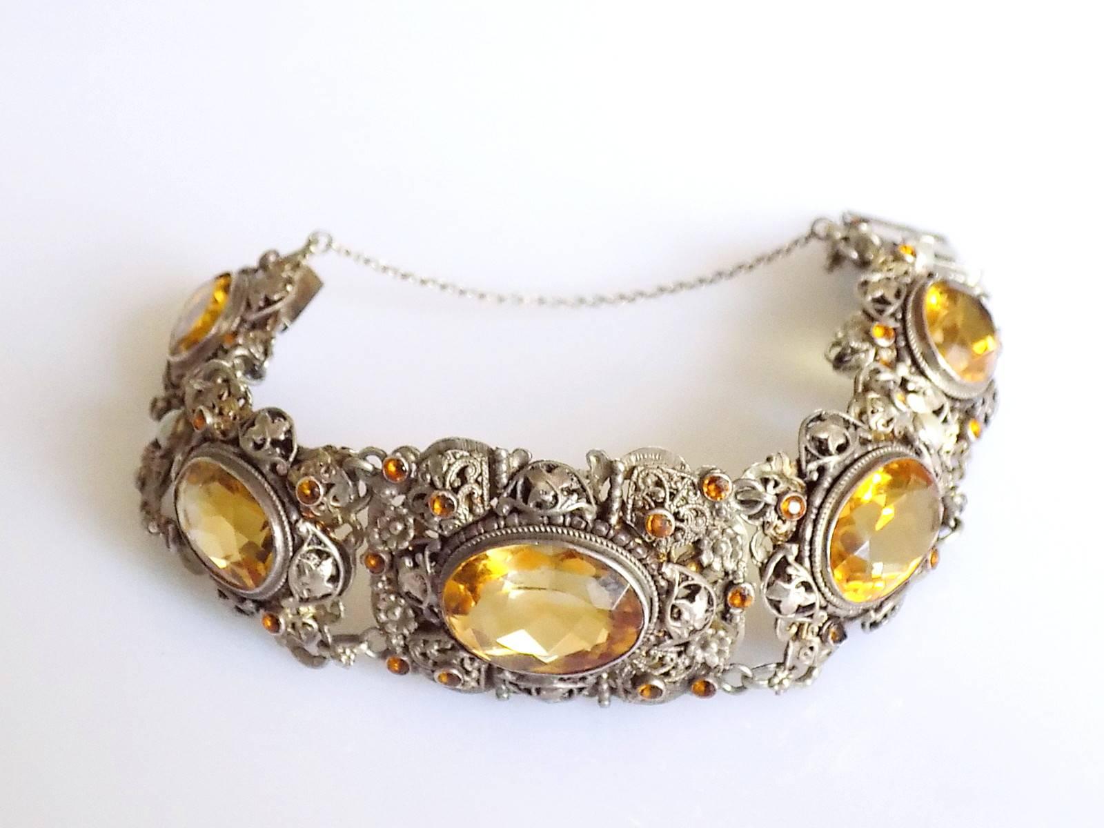 A Spectacular Antique Austro-Hungarian Silver, Natural Citrine and split Pearl bracelet. Each link beautifully designed with a large Citrine in the middle surrounded by Silver flowers, foliage and smaller Citrines. Rare and Gorgeous.
Citrine - stone