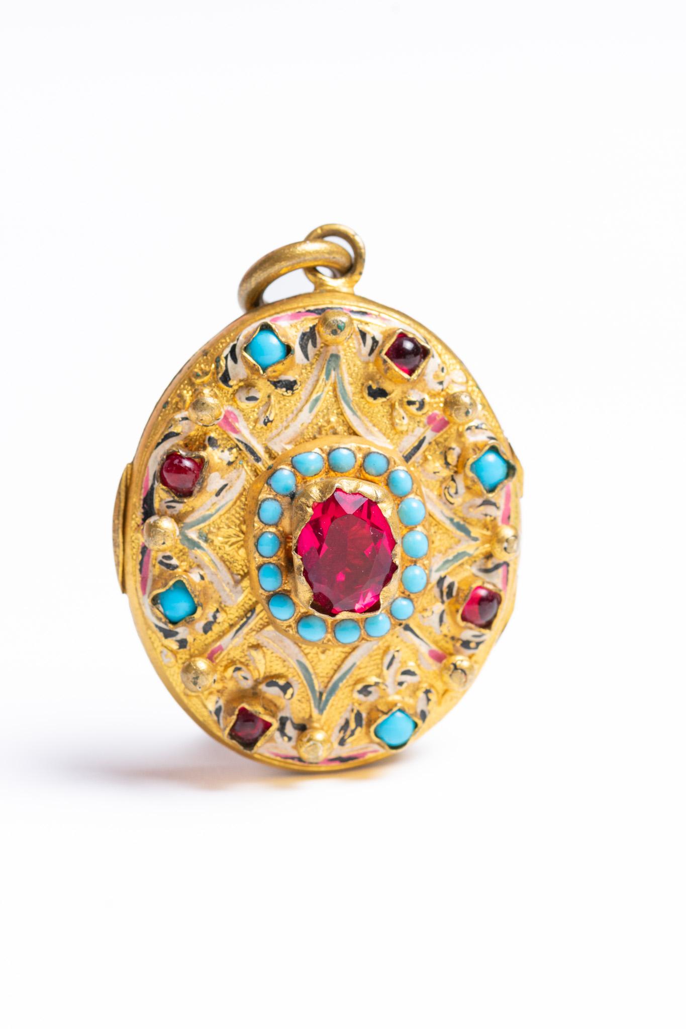 This impressive and rare Antique Austro-Hungarian Renaissance Revival Turquoise and Paste Locket dates circa 1880. In the centre there is a paste ruby stone surrounded by little turquoise stones. The piece is enamelled and decorated with paste red